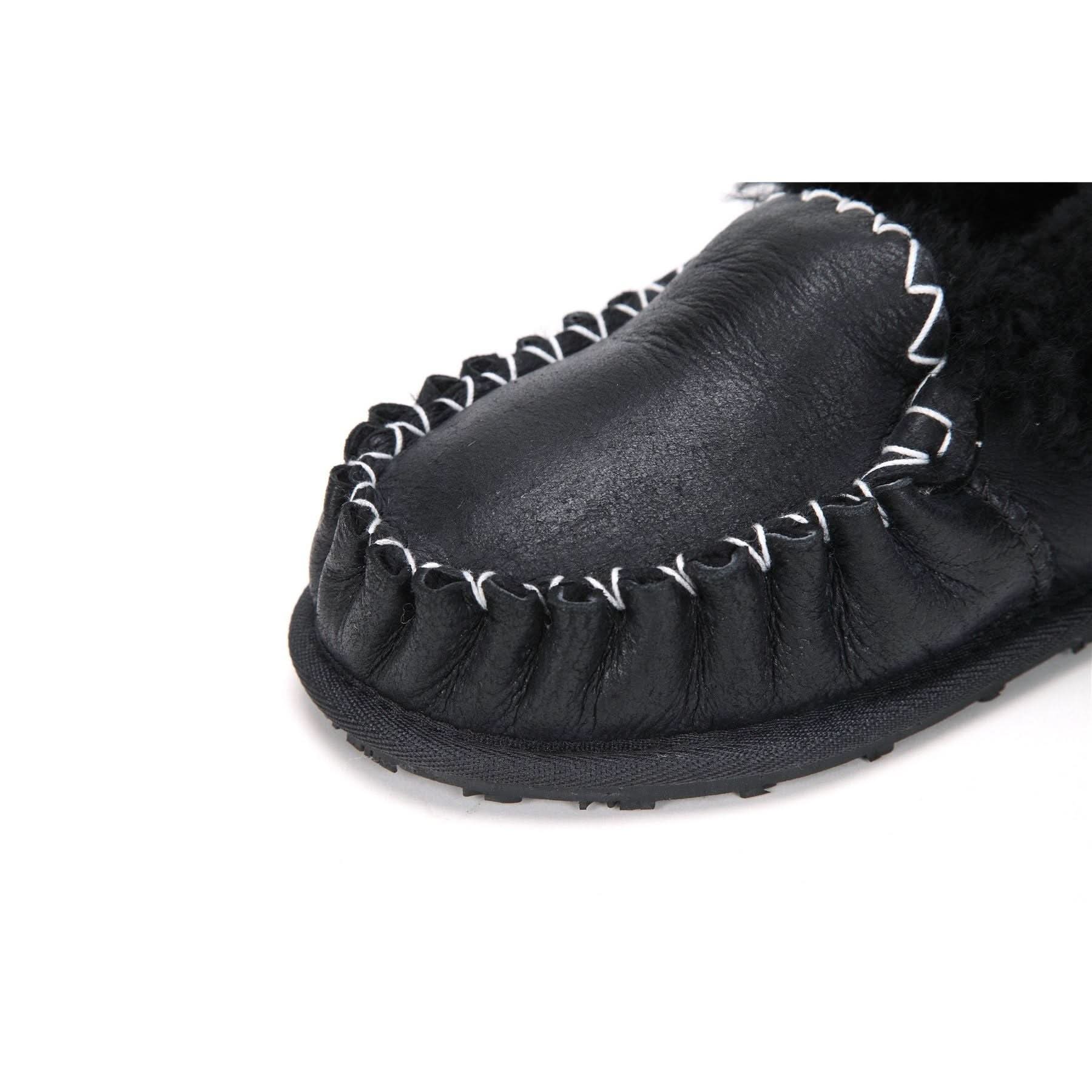 Black sheepskin moccasin slipper with white whip stitch trim, top angled view. - Yellow Earth Australia