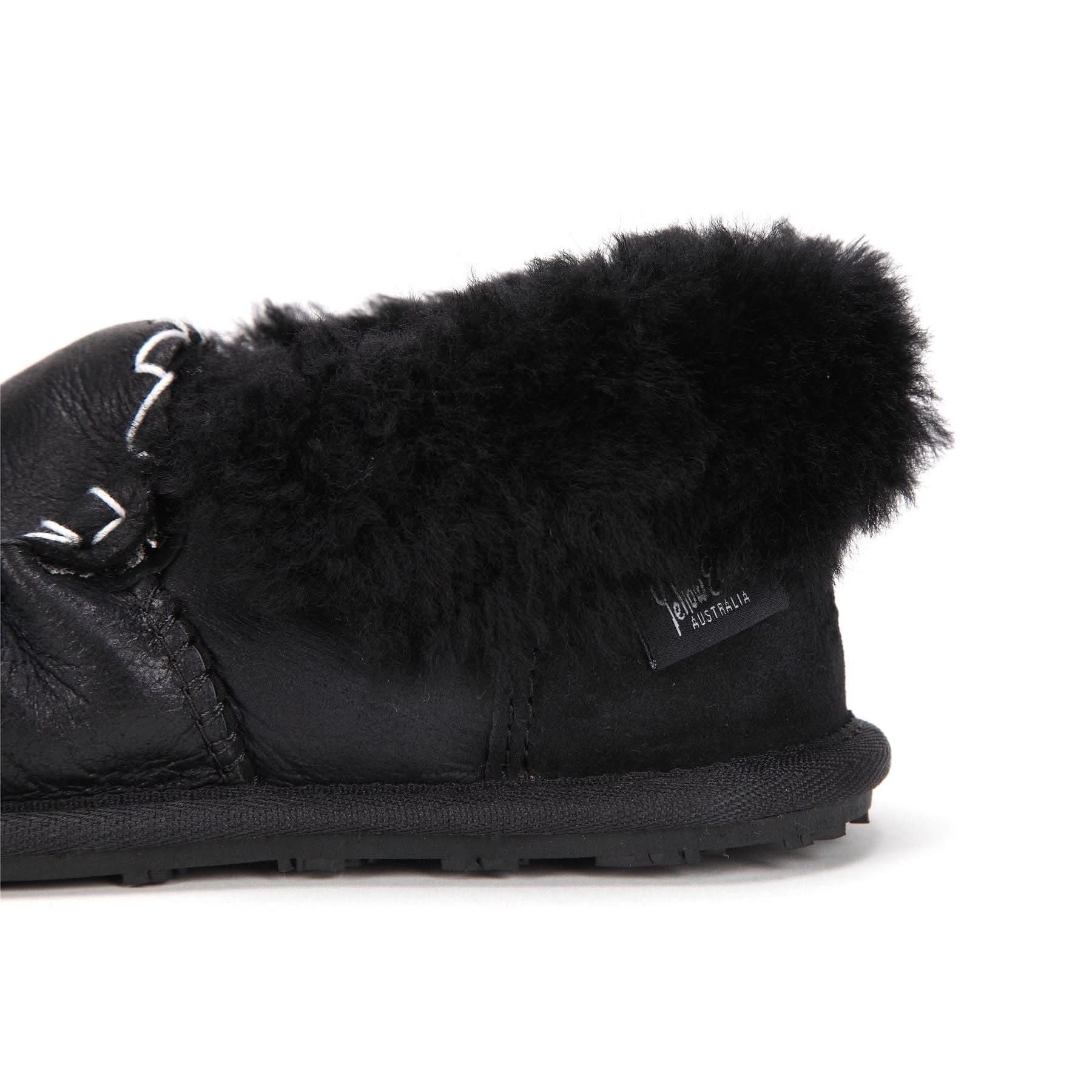Black sheepskin slipper with fluffy wool lining, side view on white background. - Yellow Earth Australia