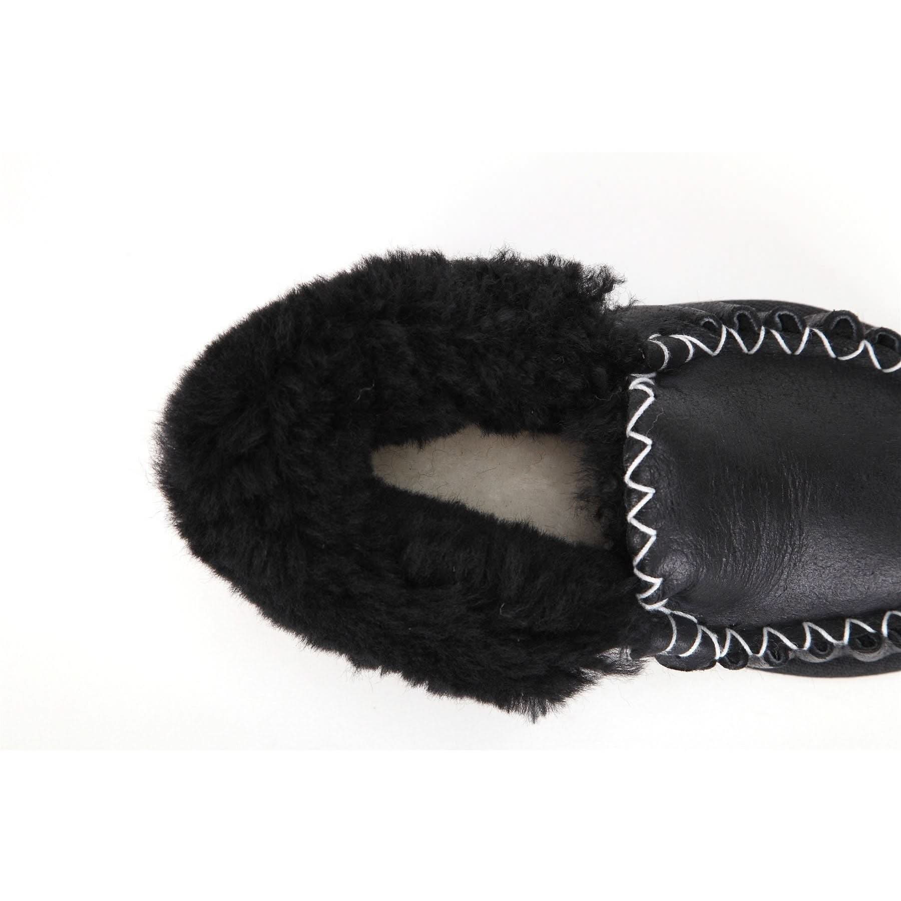 Black sheepskin moccasin with fuzzy wool lining and whipstitched leather cuff, top view. - Yellow Earth Australia