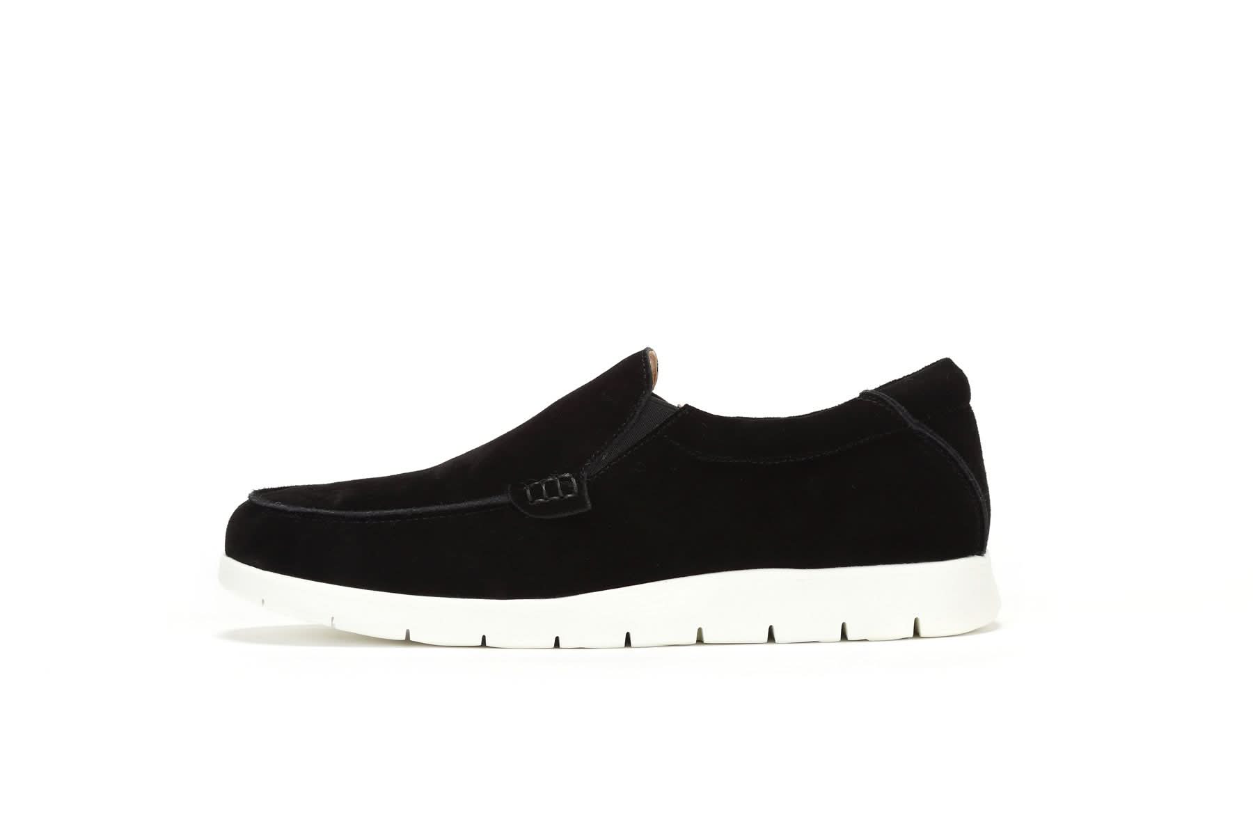 Black suede slip-on loafer with white sole, side view. - Yellow Earth Australia
