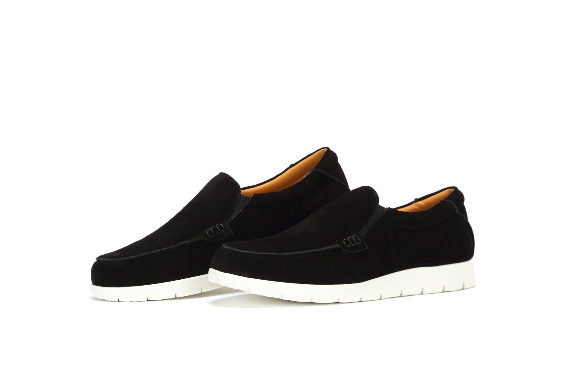 Black suede slip-on loafers with white sole and tan wool lining, side view. - Yellow Earth Australia