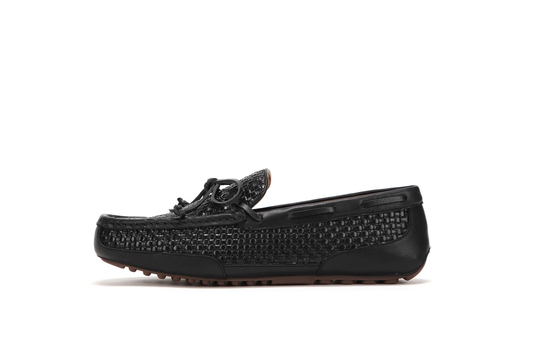 Black woven leather driving moccasin with textured upper and brown rubber sole, side view. - Yellow Earth Australia
