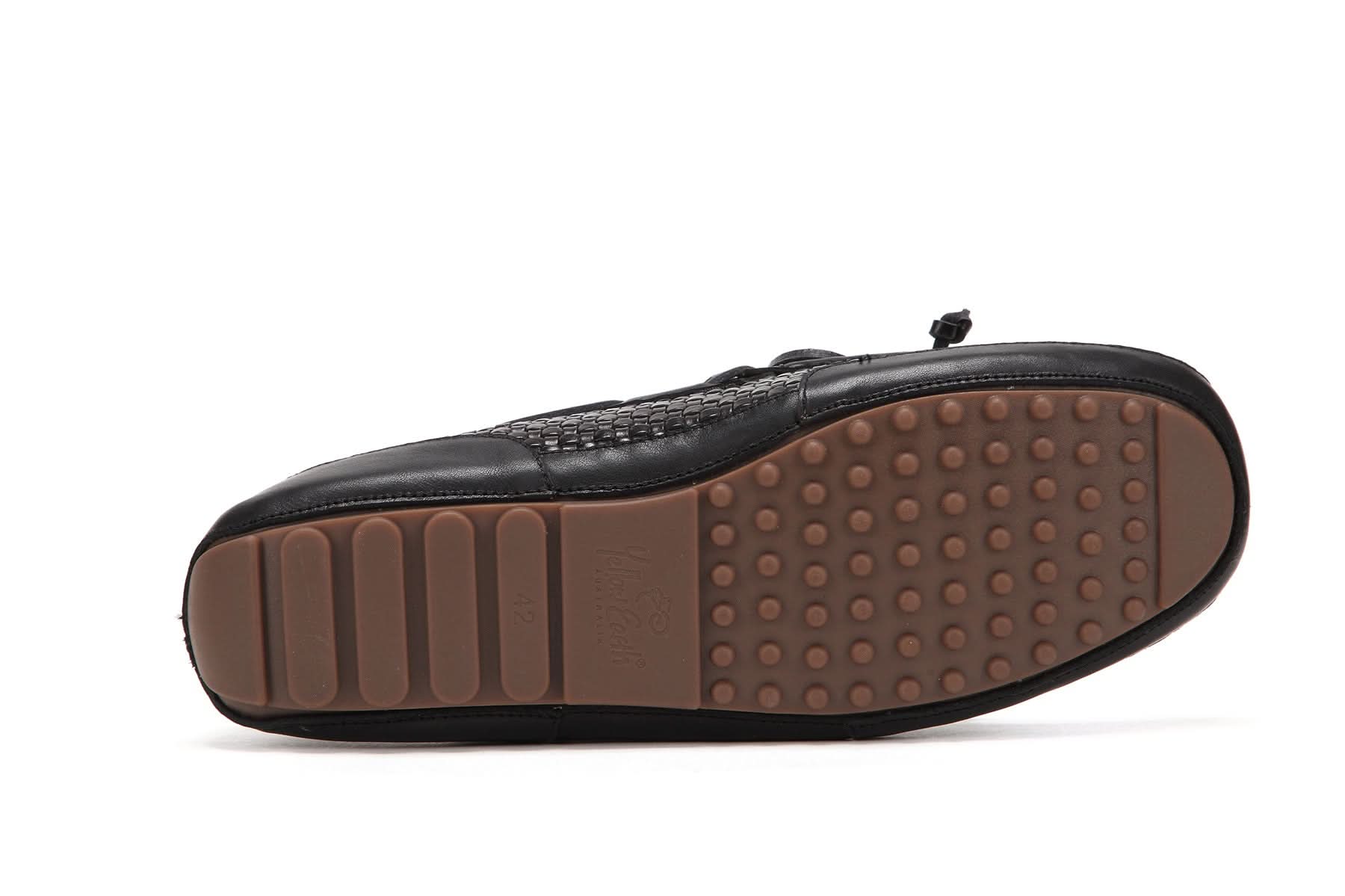 Black leather slip-on slipper with brown studded sole, bottom view. - Yellow Earth Australia