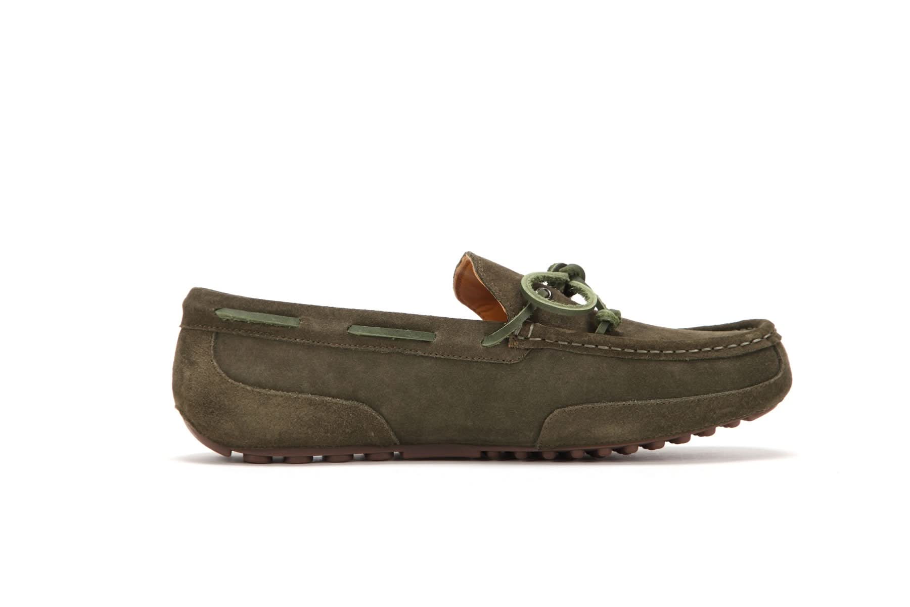 Olive green suede moccasin loafer with bow detail and rubber sole on white background