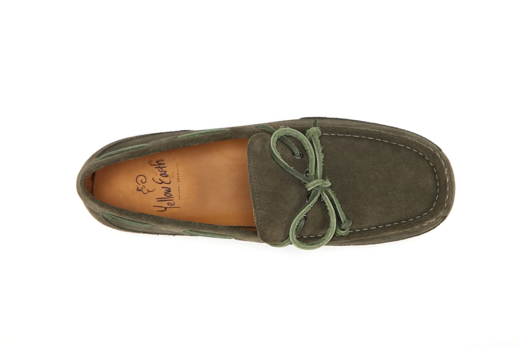 Top view of a green suede moccasin with bow and visible stitching on white background
