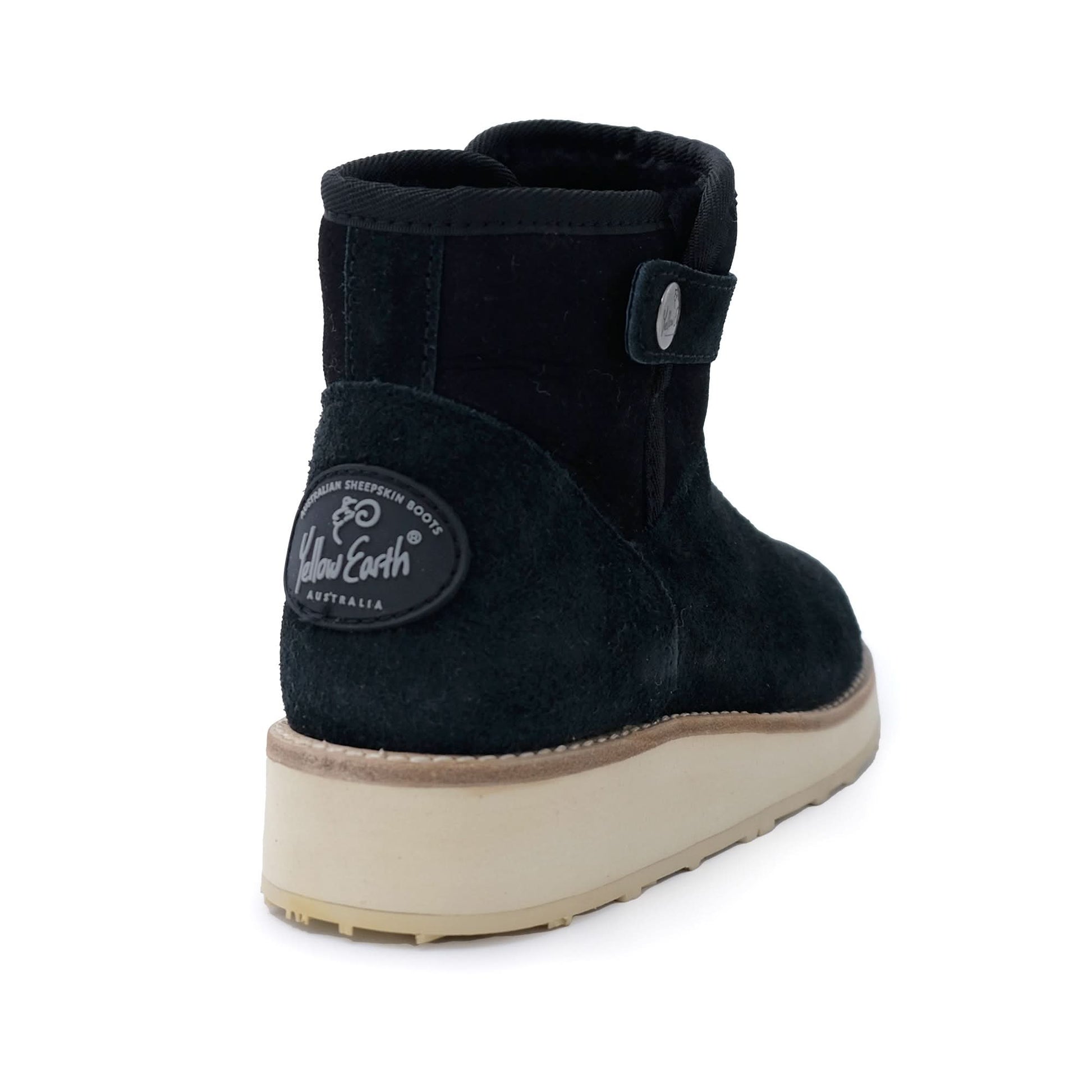 Black sheepskin ankle boot with cream sole, rear three-quarter view. - Yellow Earth Australia