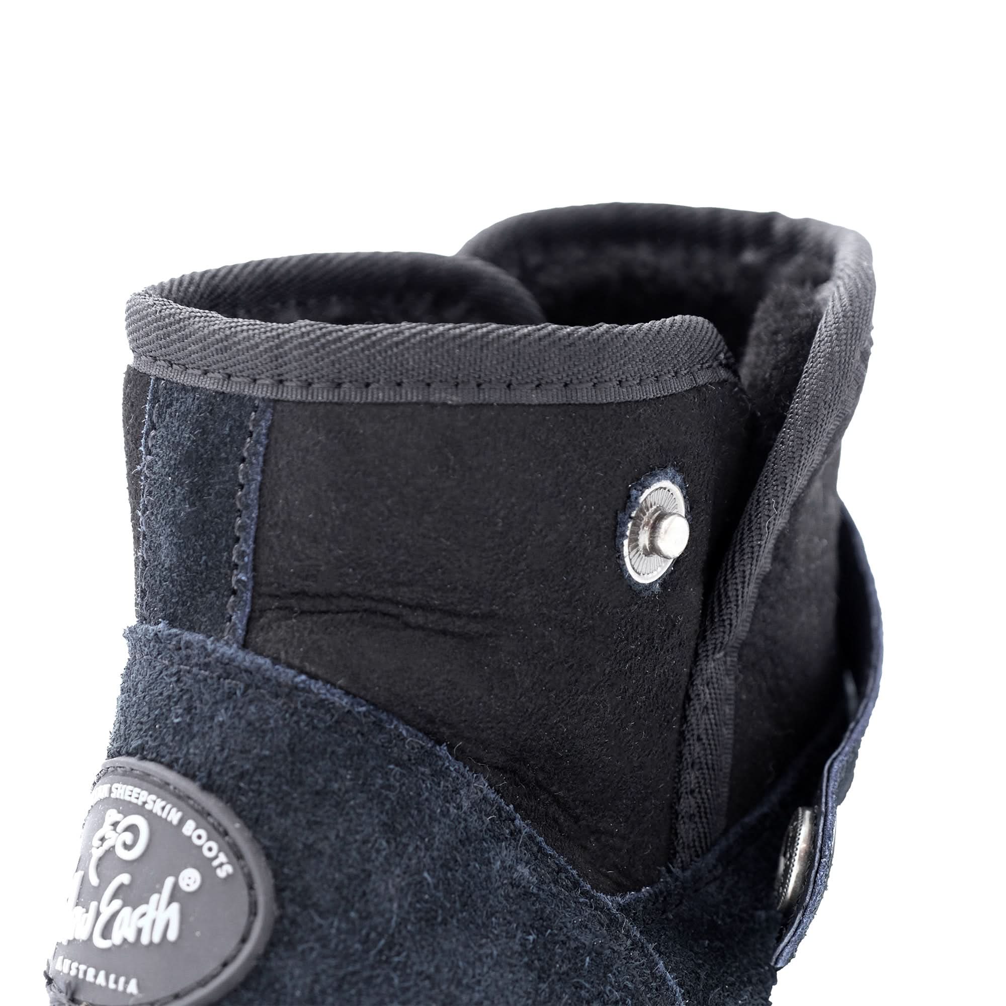 Black sheepskin boots with wool lining, side view showing texture and metal button detail. - Yellow Earth Australia