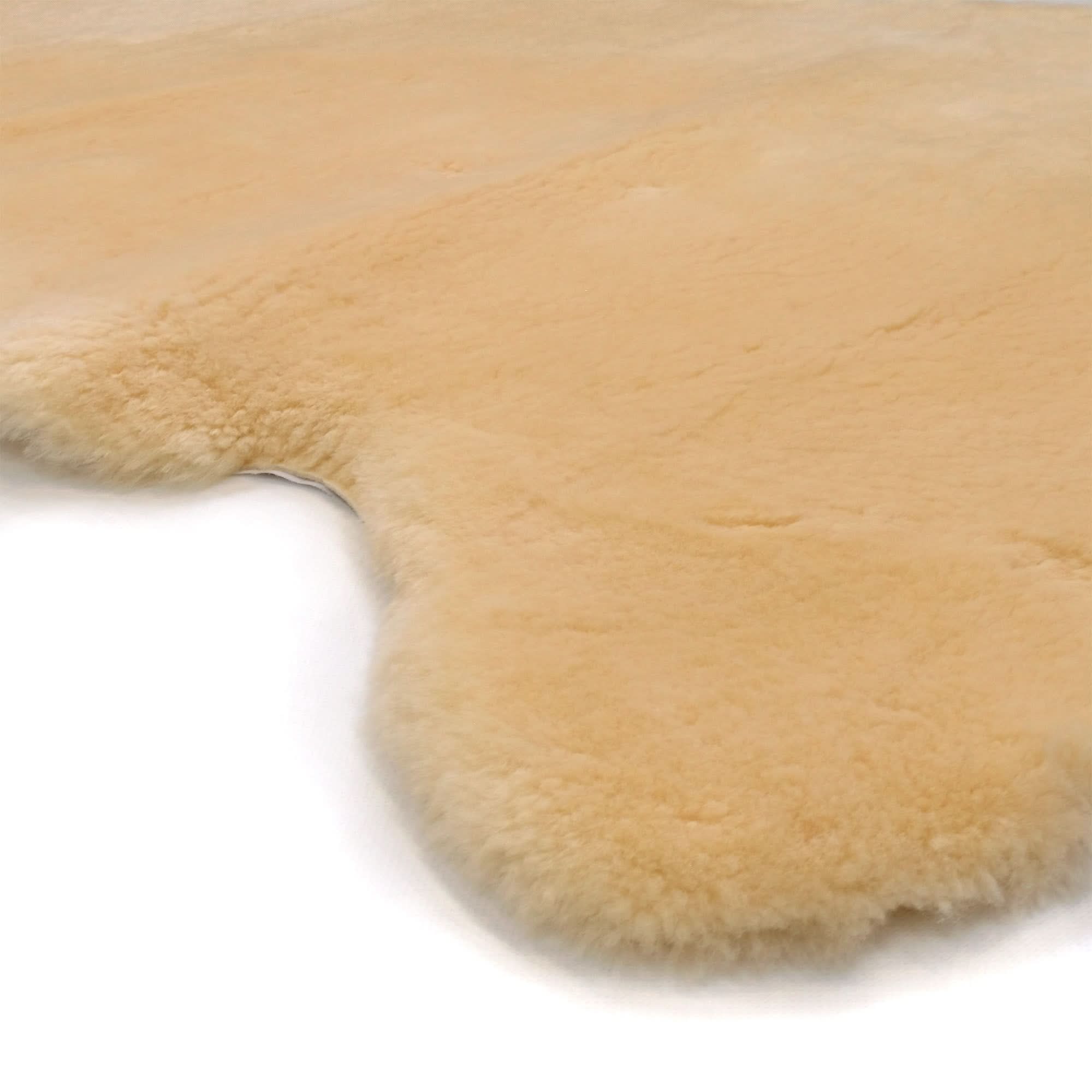 Natural sheepskin rug with soft wool pile in cream colour, top-down view. - Yellow Earth Australia