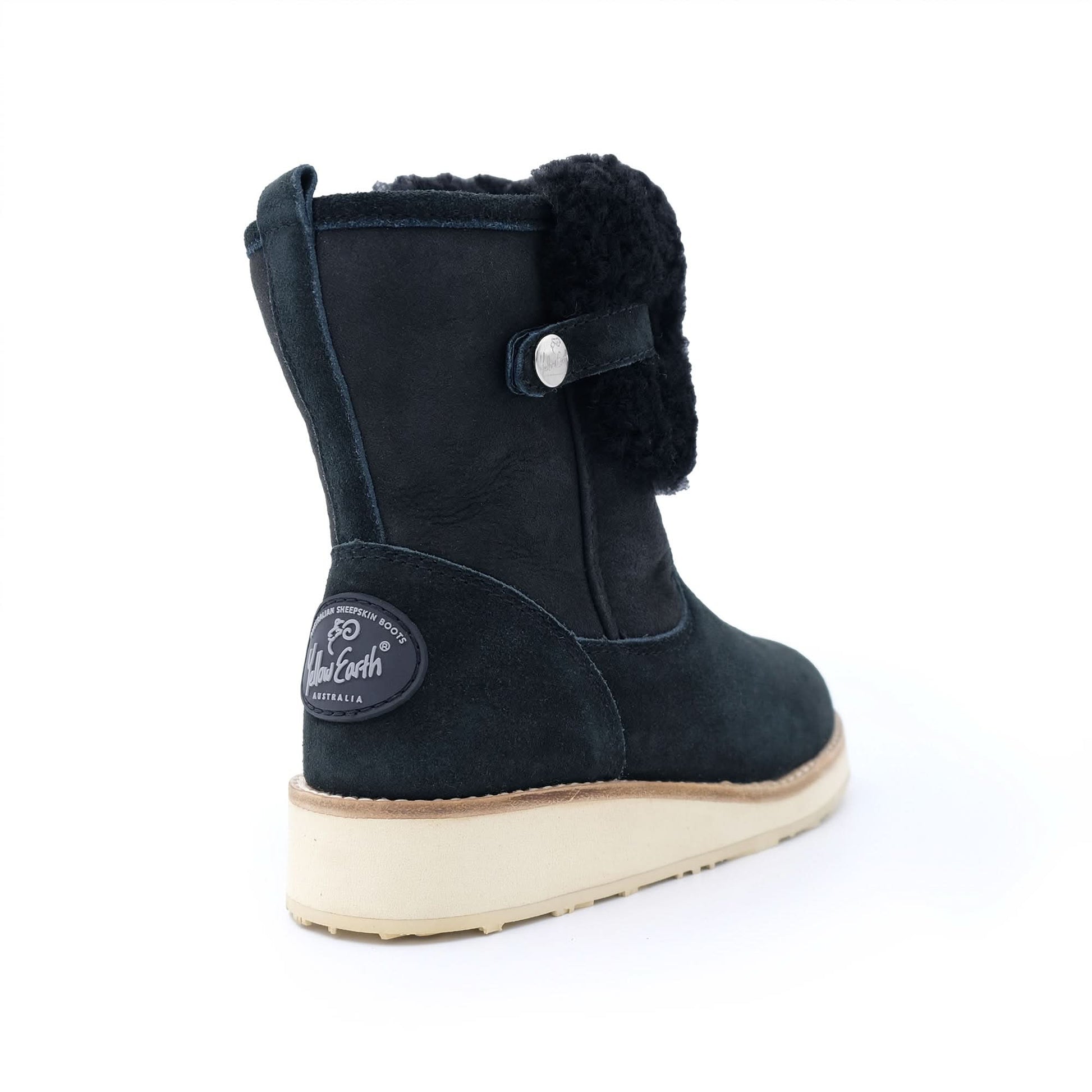 Black sheepskin winter boot with cream sole, rear three-quarter view. - Yellow Earth Australia