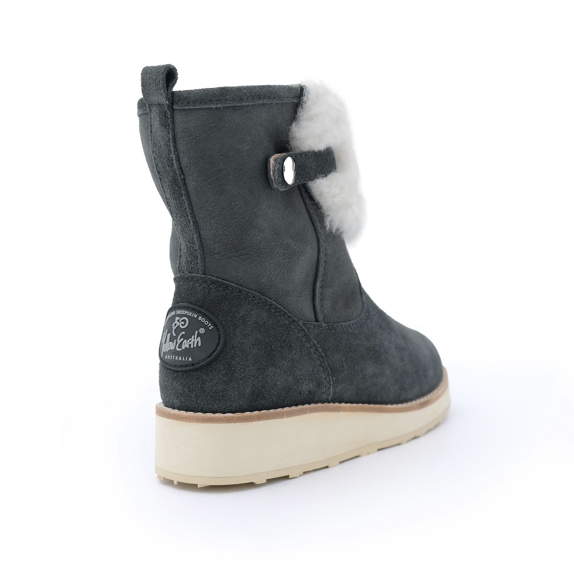 Gunmetal grey sheepskin boot with white fleece lining and beige sole on white background