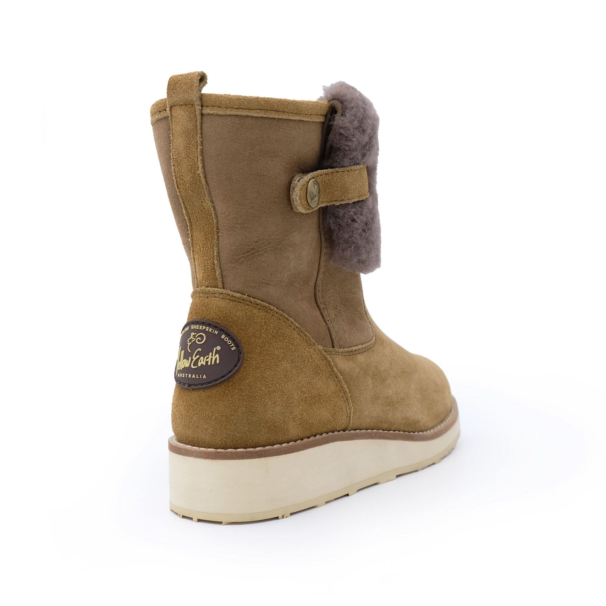Tan sheepskin boot with side button, wool lining and rubber sole on white background