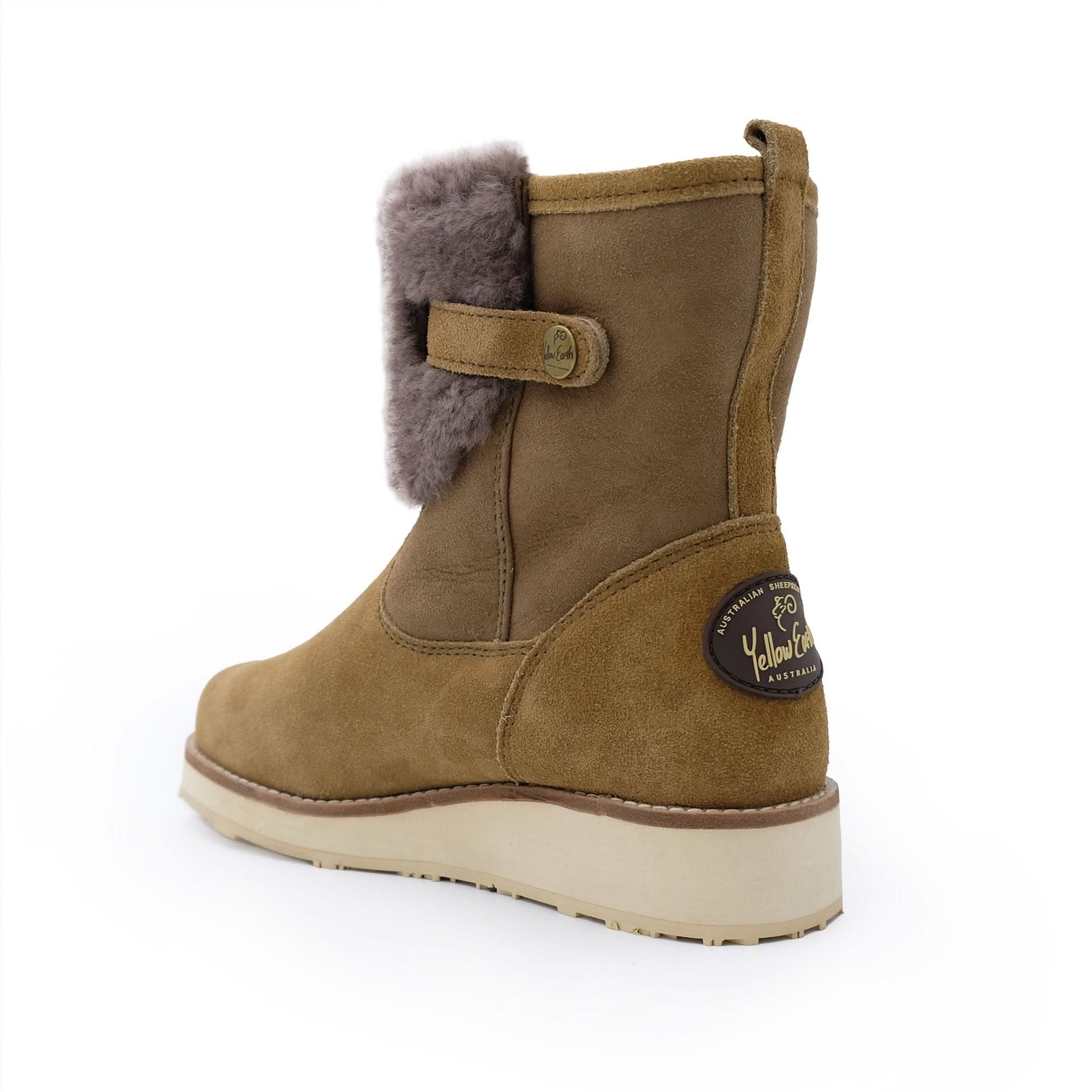 Mid-calf tan sheepskin boot with side button, wool lining, and rubber sole on white background.