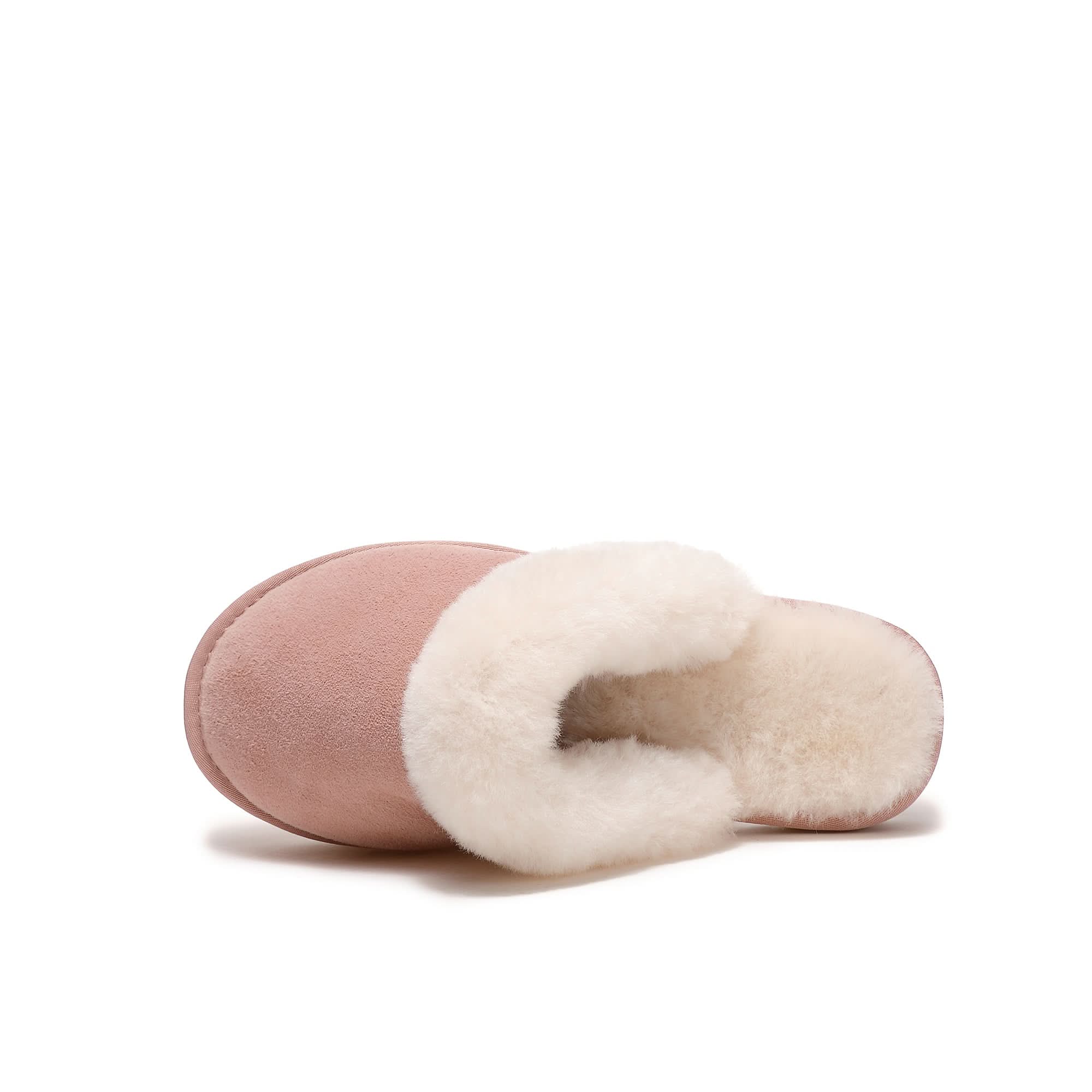 Blush pink sheepskin slipper with cream fleece lining, angled side view. - Yellow Earth Australia