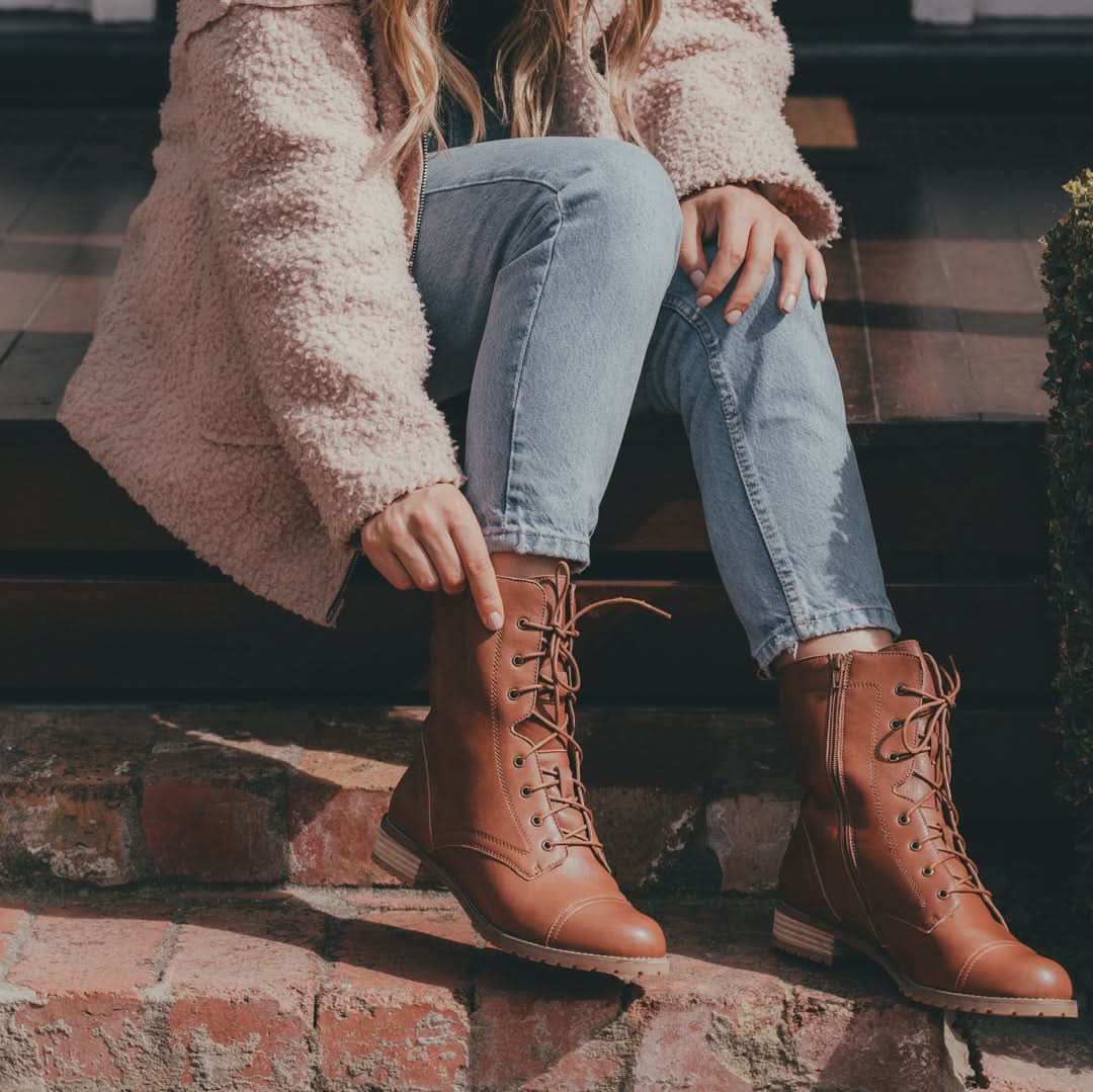 Cognac leather lace-up boots with wooden heel, styled with light denim jeans and pink wool jumper. - Yellow Earth Australia