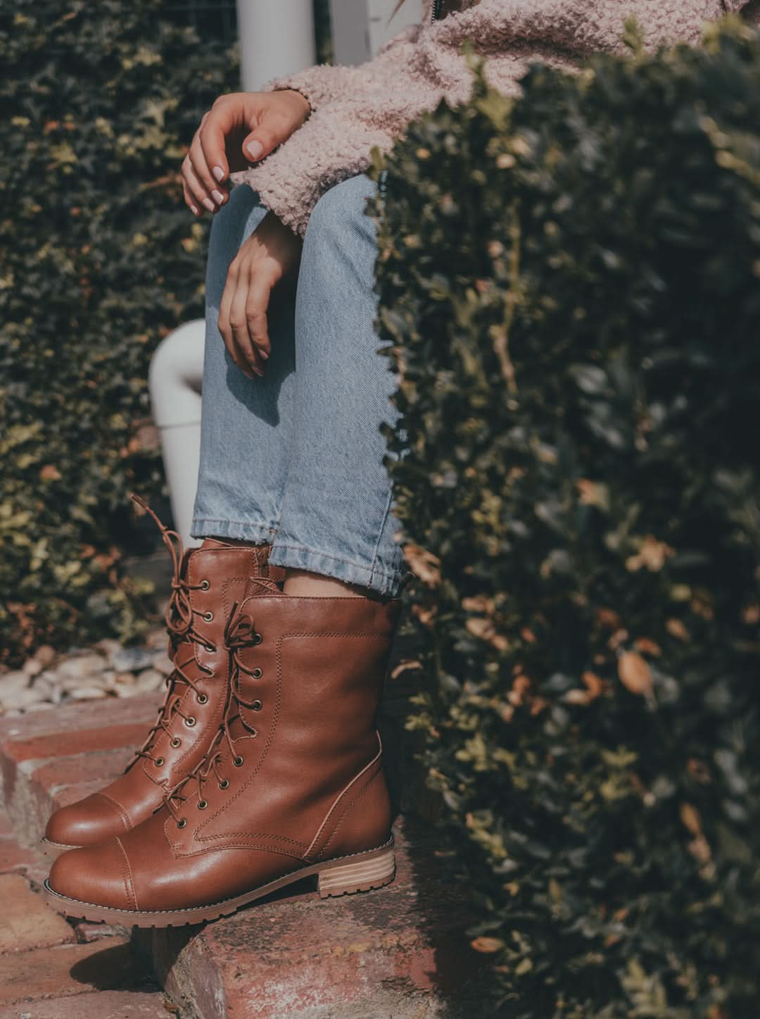 Tan lace-up leather boots with wool lining, worn with jeans and pink sweater. - Yellow Earth Australia