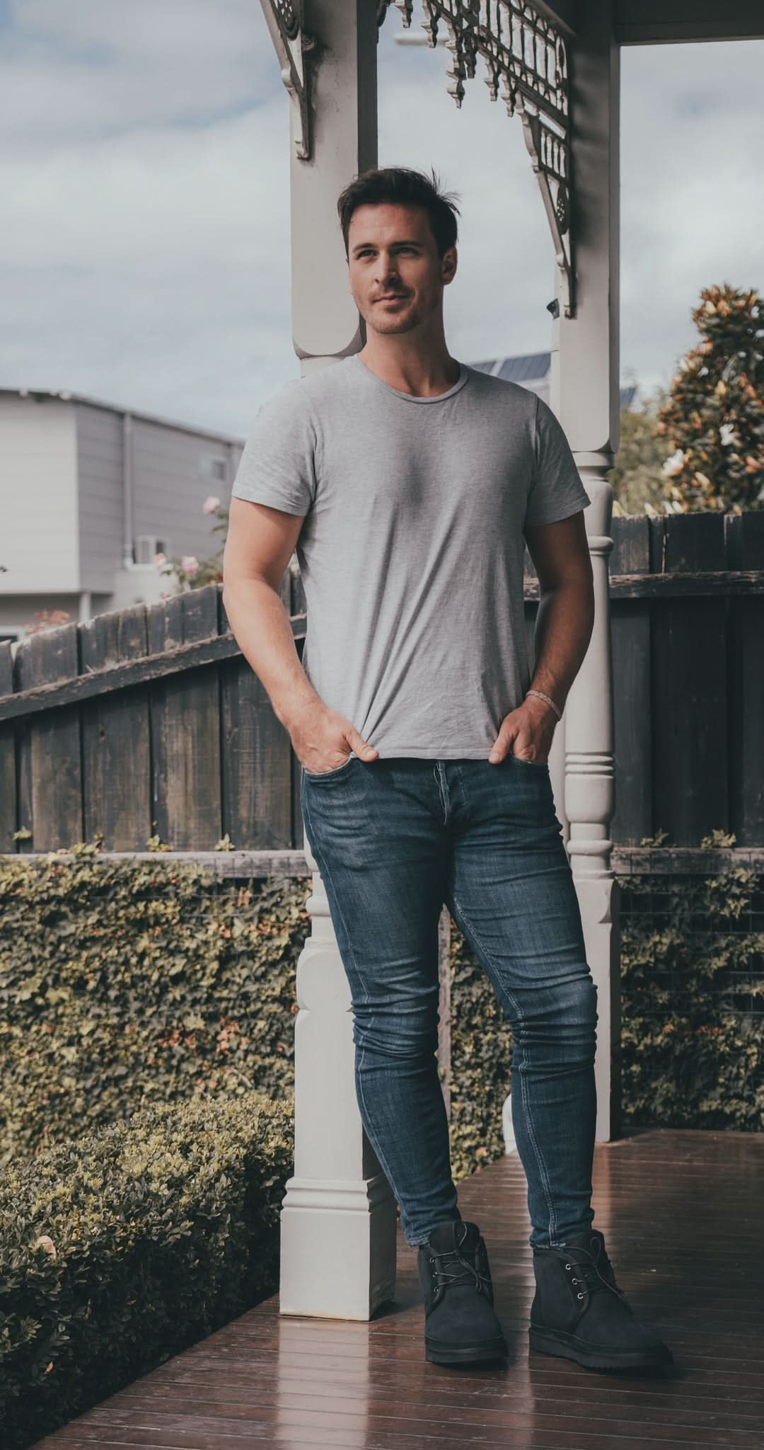 Grey crew neck short sleeve wool t-shirt with dark jeans, front view. - Yellow Earth Australia