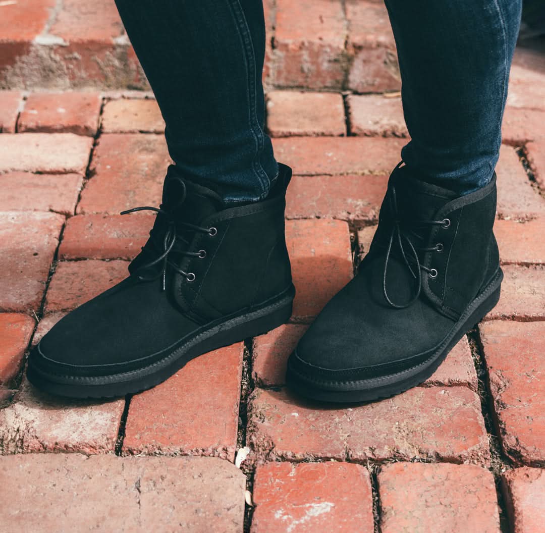 Black suede desert boots with crepe sole on brick surface, front view. - Yellow Earth Australia
