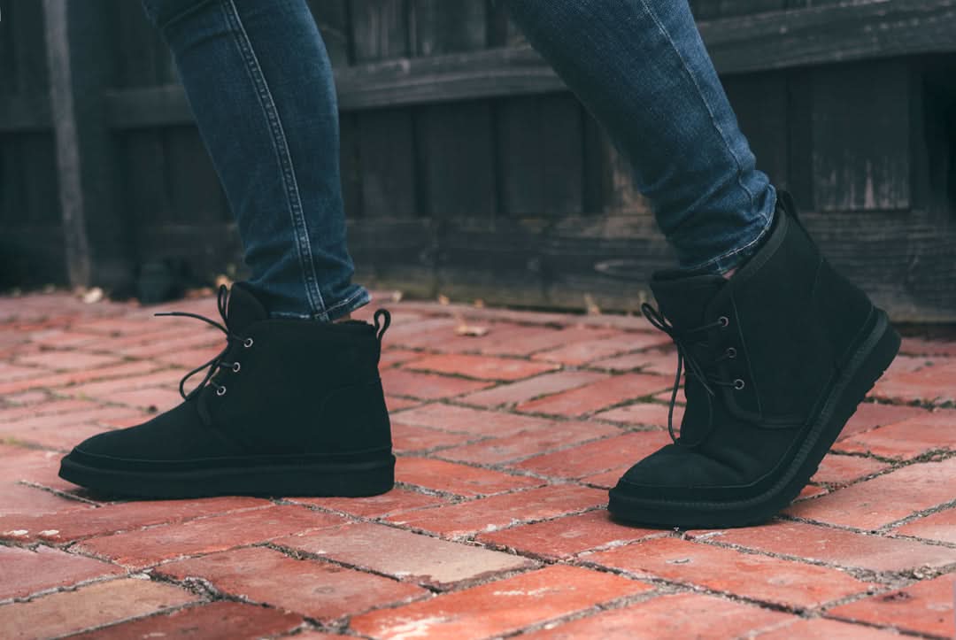 Black suede lace-up ankle boots with sheepskin lining worn with jeans on brick pavement. - Yellow Earth Australia