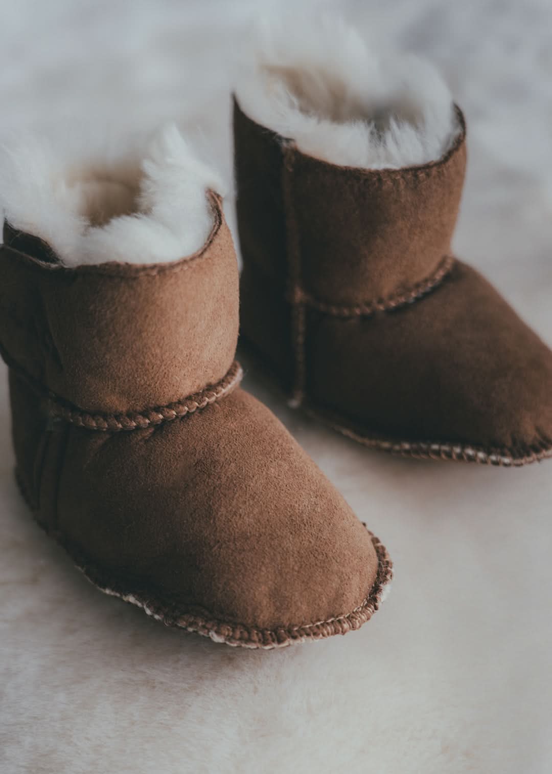 Pair of chestnut suede baby boots with white sheepskin lining, top view. - Yellow Earth Australia