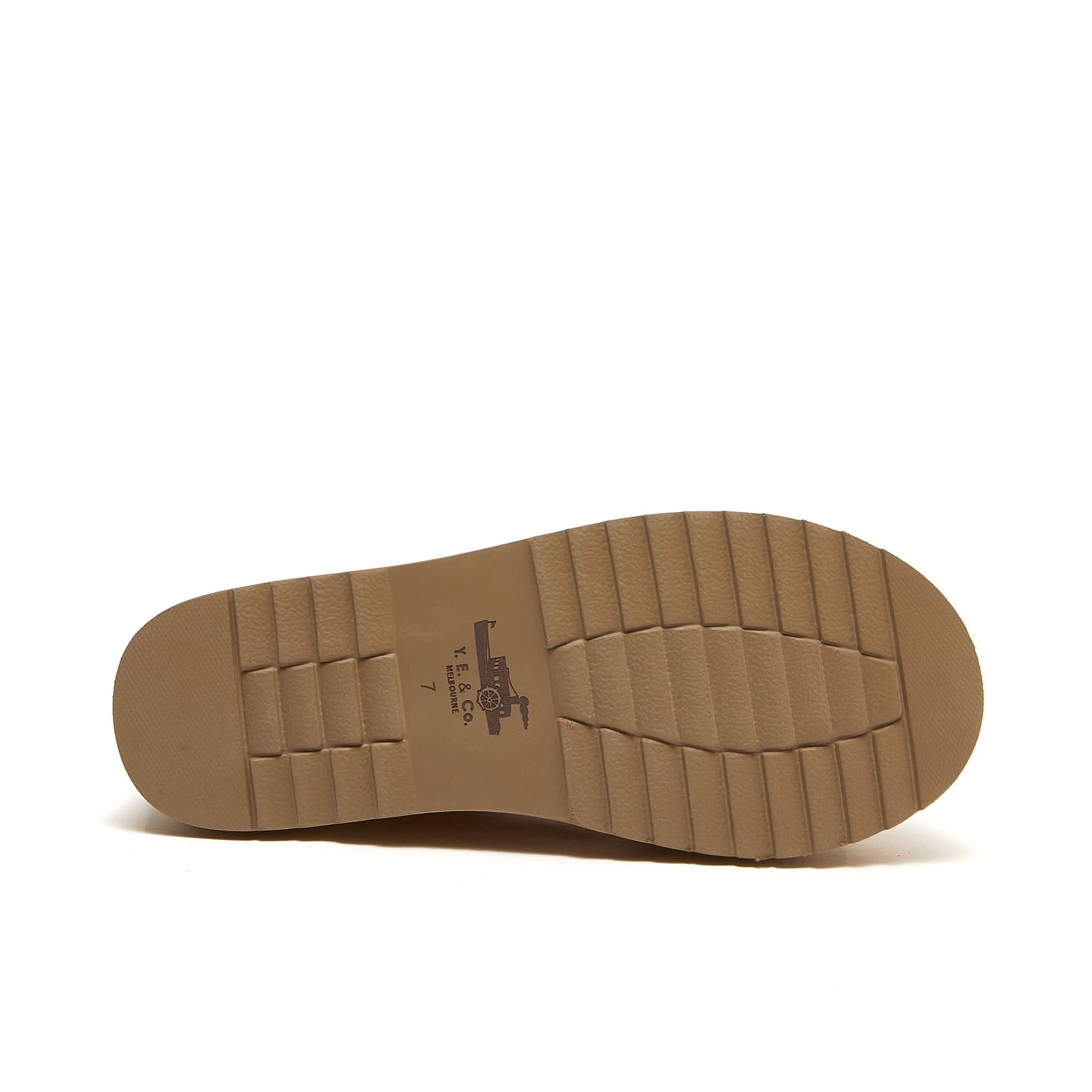 Tan leather shoe sole with textured tread pattern shown from underside view. - Yellow Earth Australia