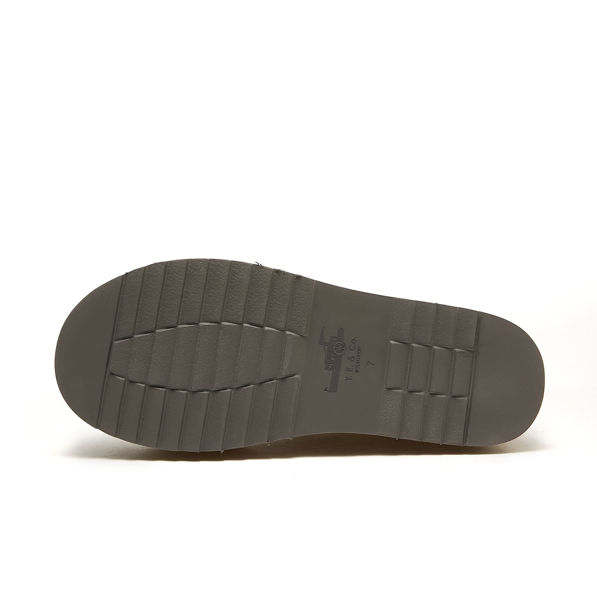 Taupe sheepskin boot sole showing textured rubber tread pattern from underneath. - Yellow Earth Australia