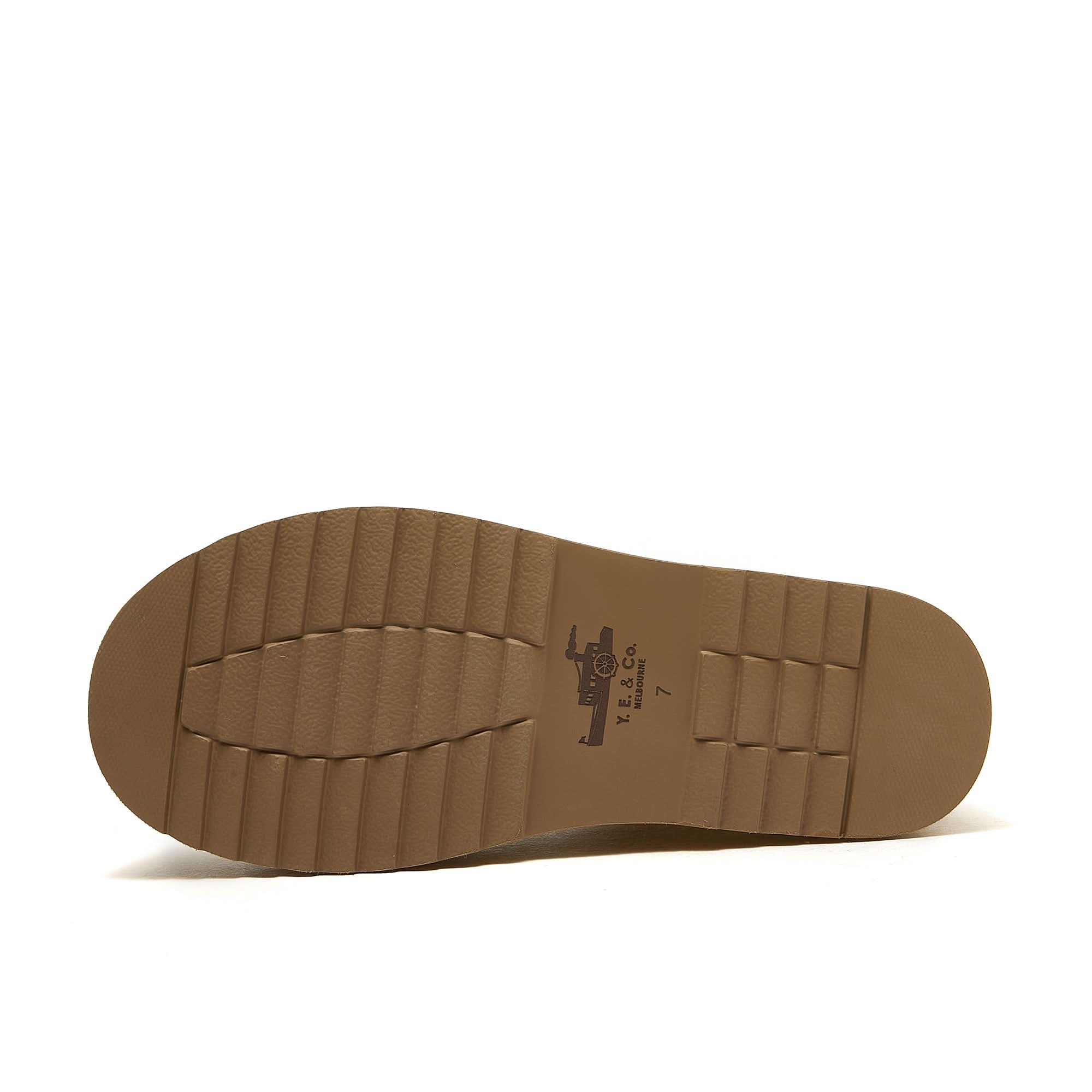 Tan leather boot sole with deep tread pattern, bottom view. - Yellow Earth Australia
