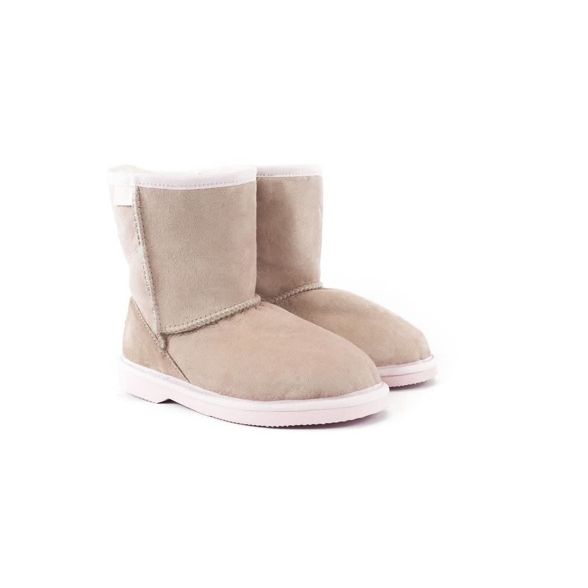 Pair of beige sheepskin boots with white sole and fleece lining, displayed from the side. - Yellow Earth Australia