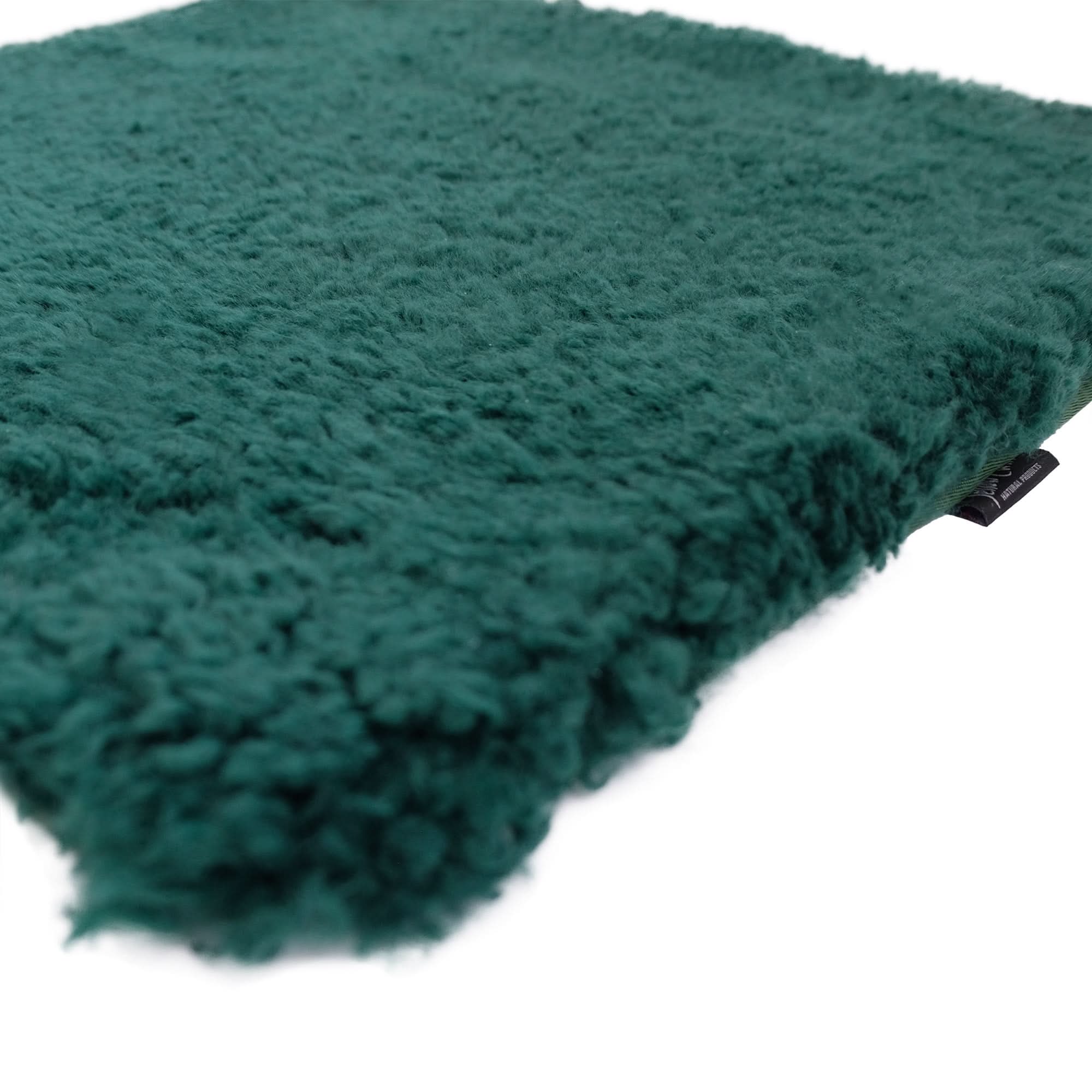 Teal sheepskin rug with thick wool pile shown at an angled perspective on white background. - Yellow Earth Australia