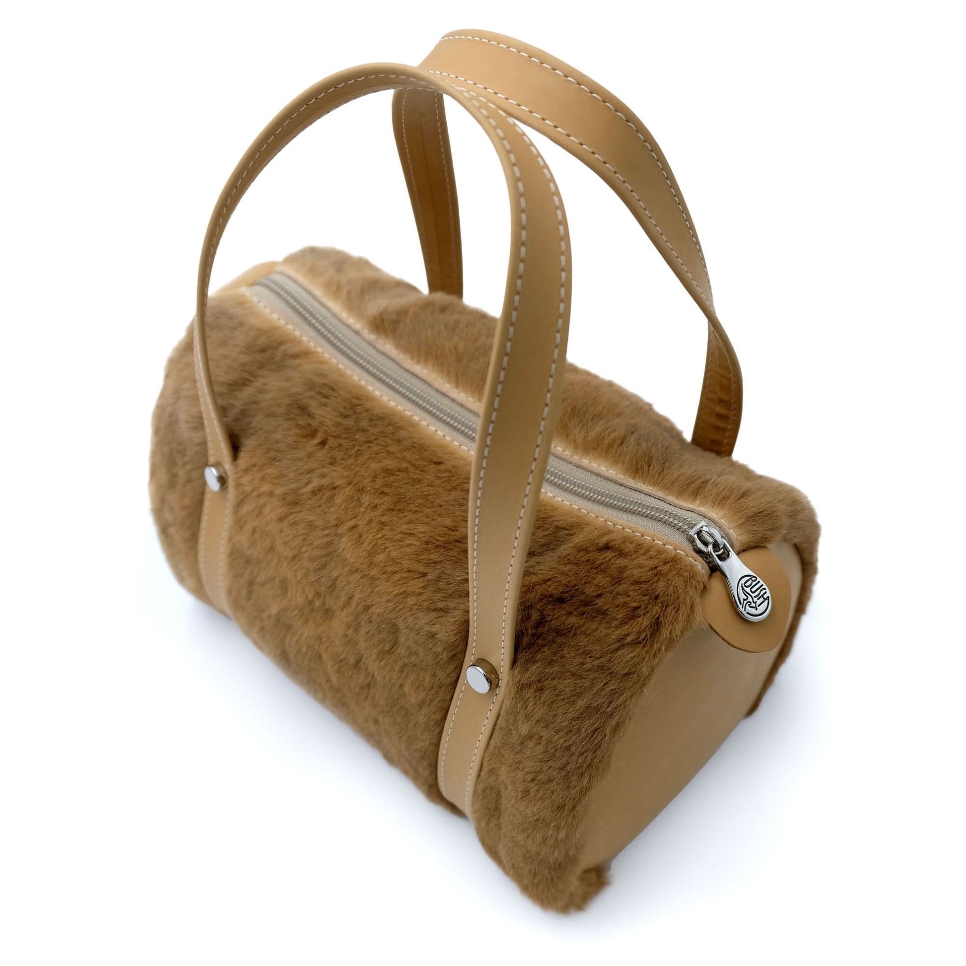 Camel sheepskin handbag with leather handles, top view showing soft fur texture and zippered comp... - Yellow Earth Australia