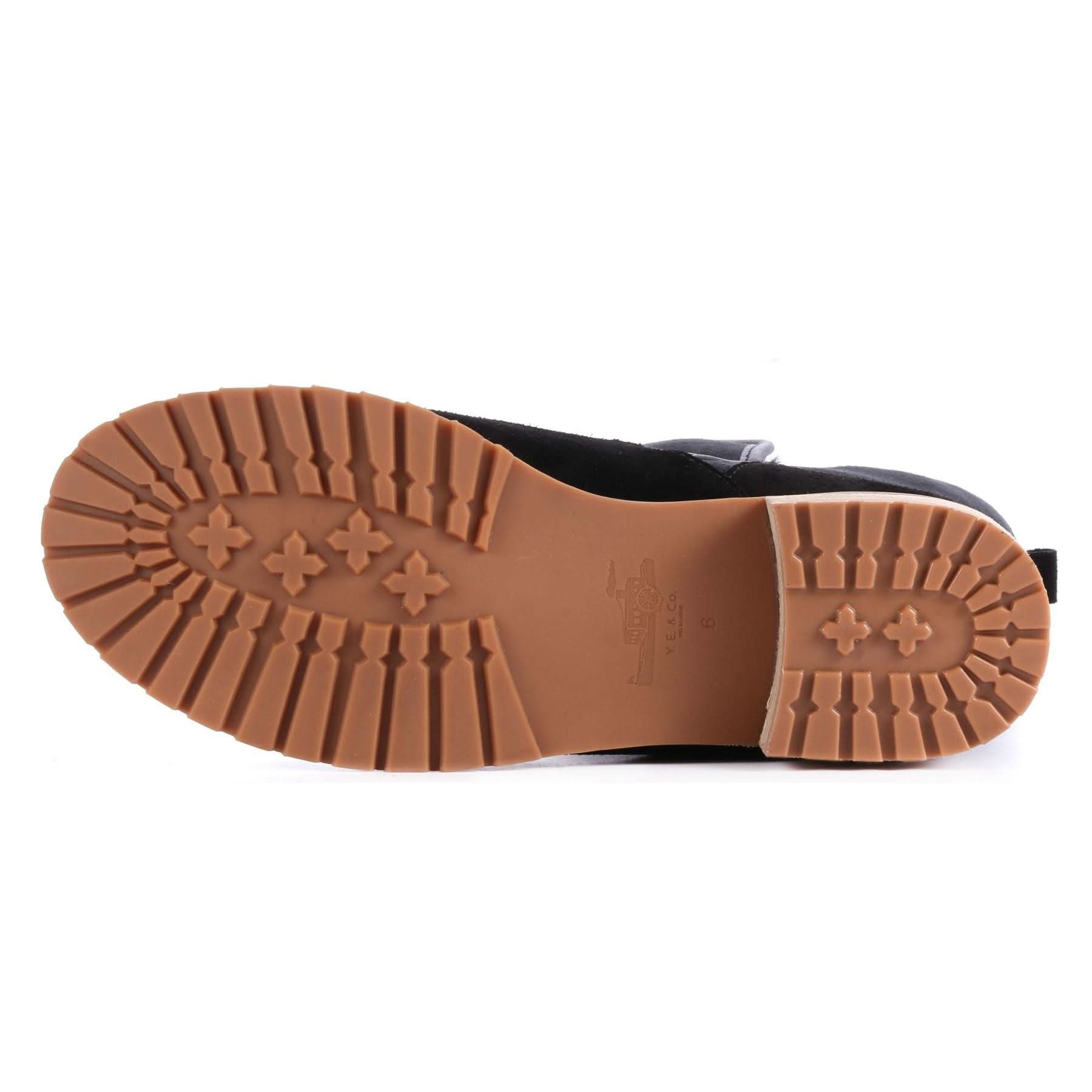 Black leather boot sole showing tan rubber tread pattern from underneath view. - Yellow Earth Australia