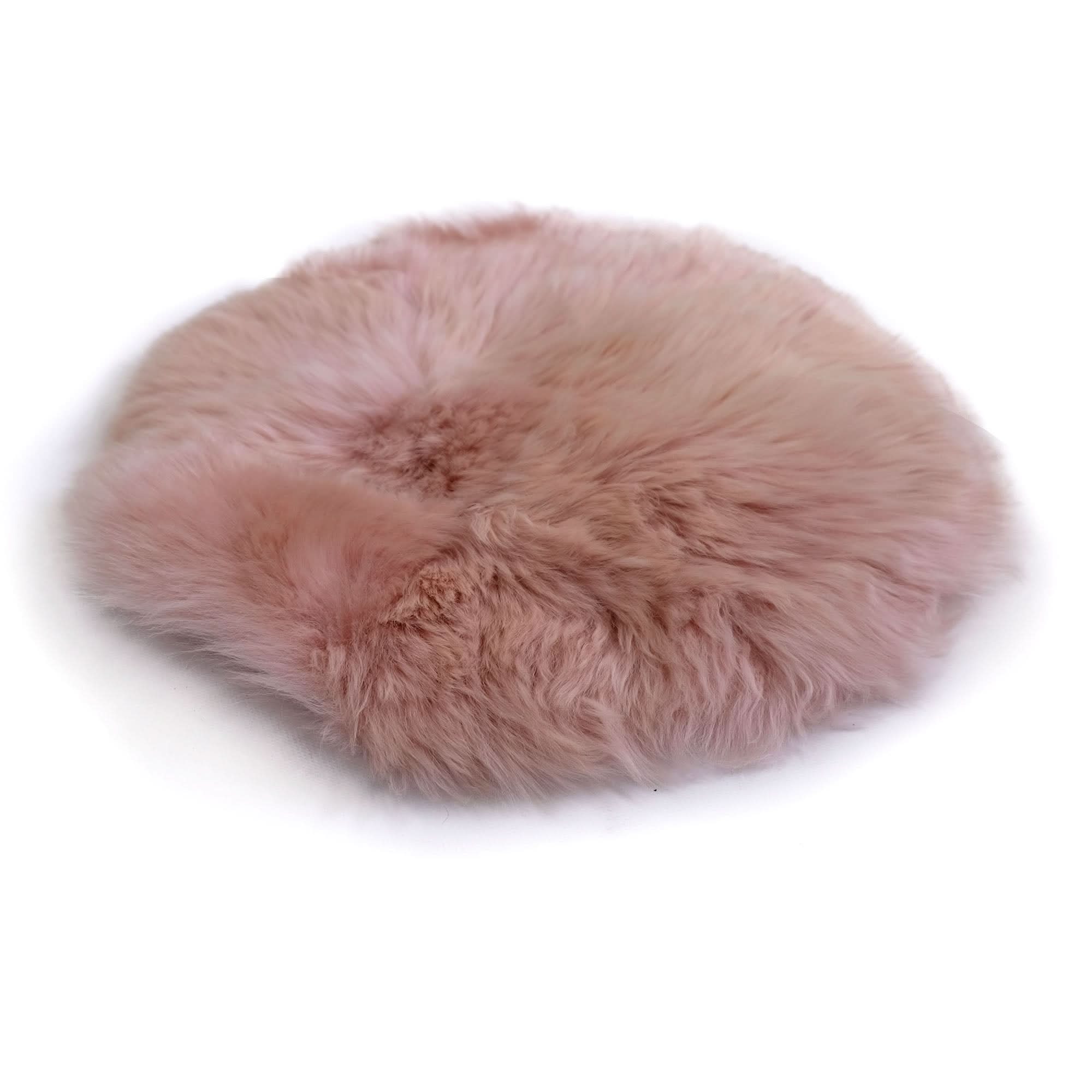 Soft pink sheepskin rug with fluffy wool texture, top view on white background. - Yellow Earth Australia