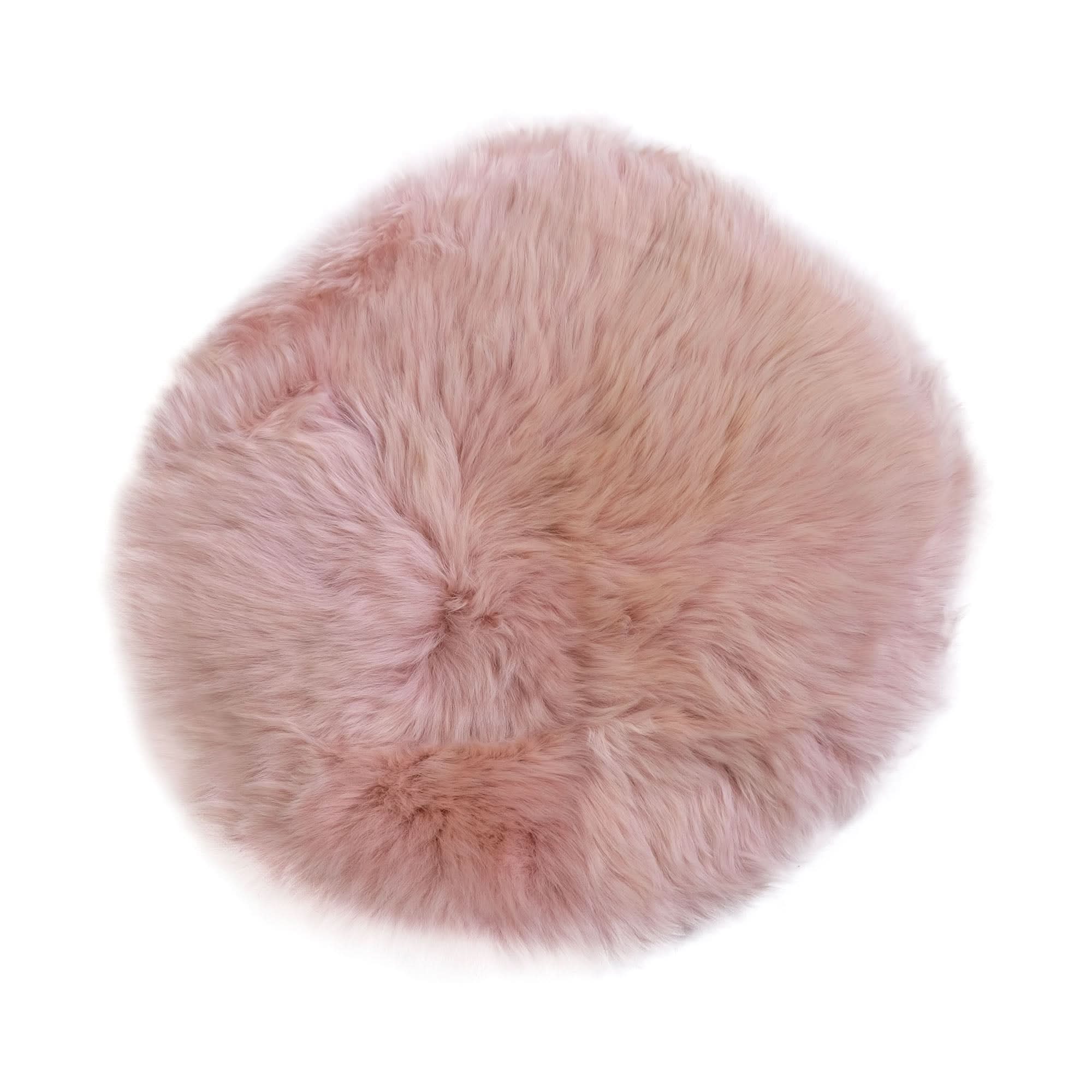 Soft pink sheepskin round rug viewed from above, showing fluffy wool texture. - Yellow Earth Australia