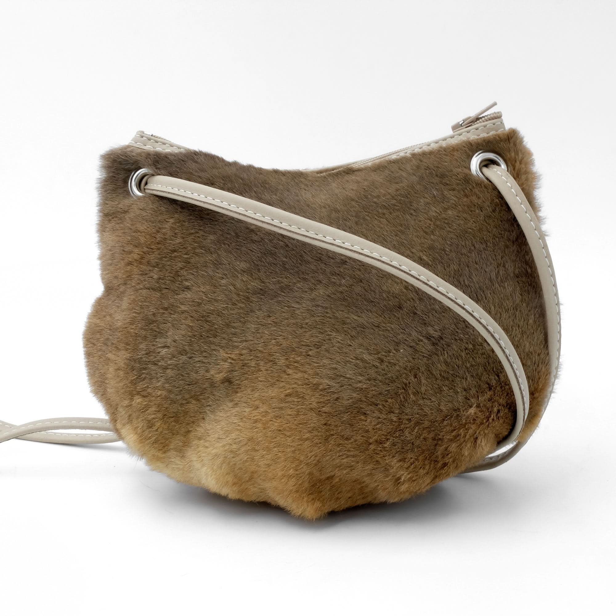 Tan sheepskin shoulder bag with cream leather strap, side view. - Yellow Earth Australia