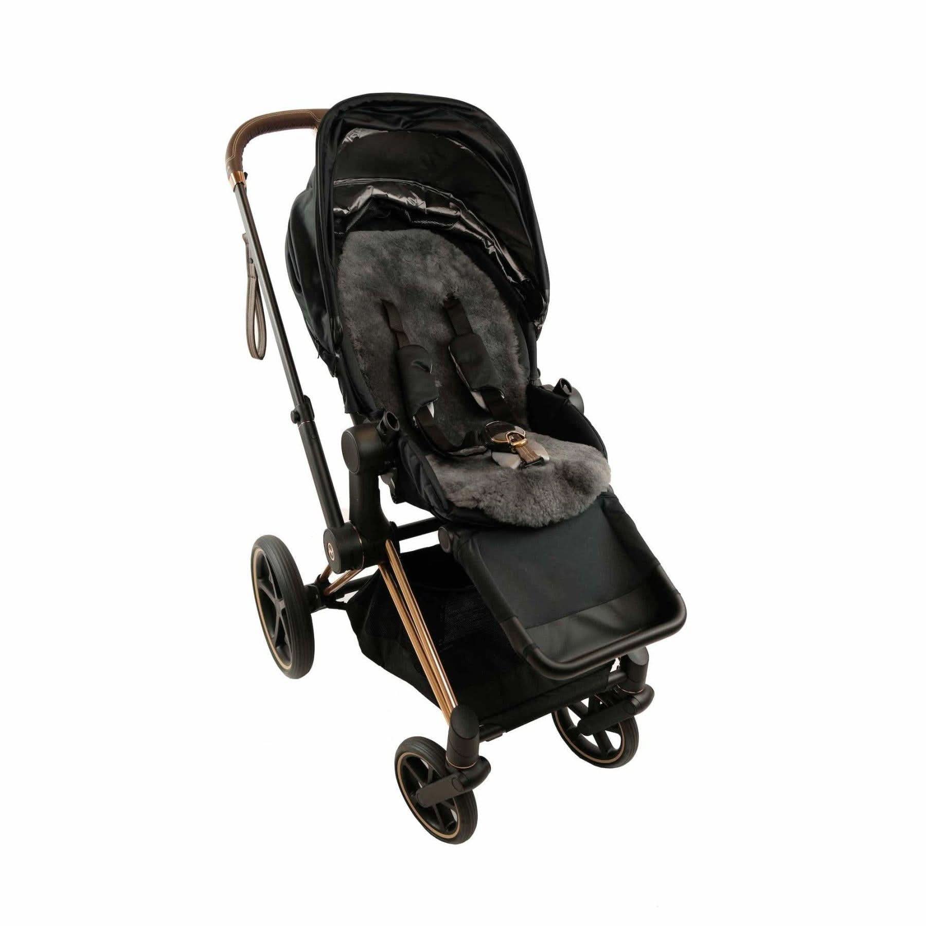 Black sheepskin pram liner with grey wool lining, overhead view. - Yellow Earth Australia