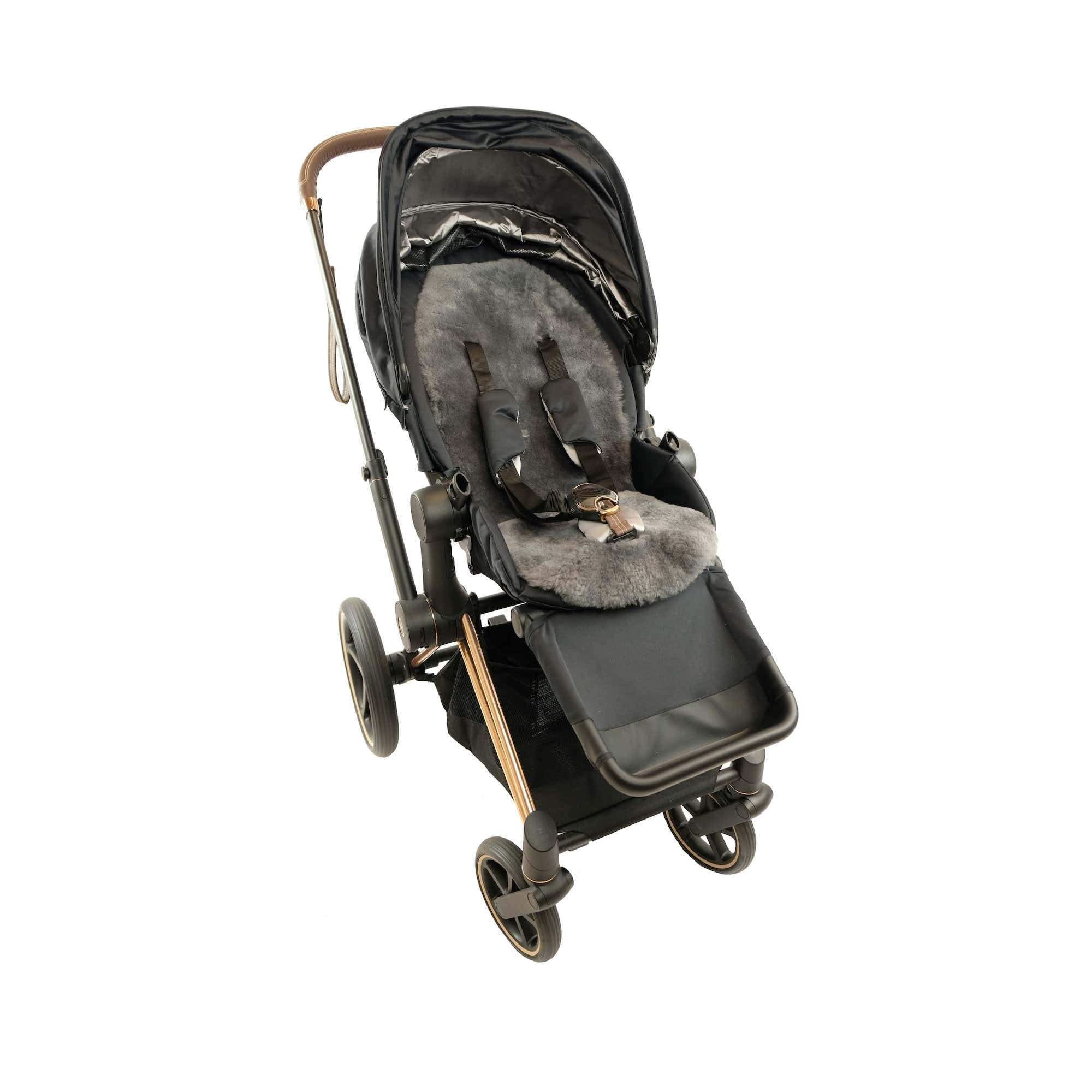 Black and grey sheepskin pram liner viewed from above on modern stroller. - Yellow Earth Australia