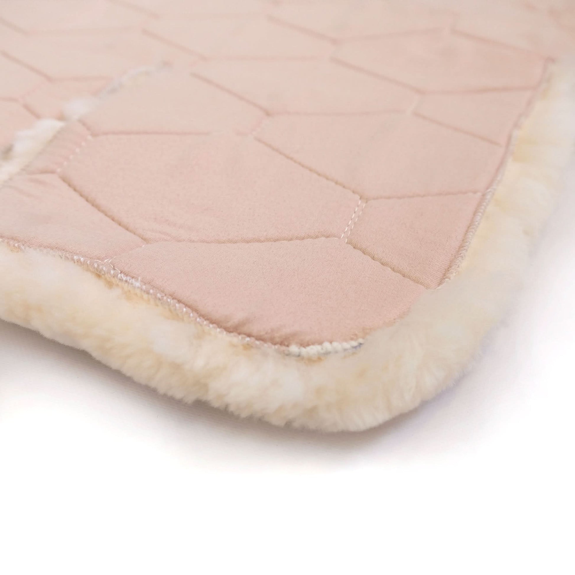 Blush pink quilted sheepskin throw with cream wool lining, folded edge detail. - Yellow Earth Australia