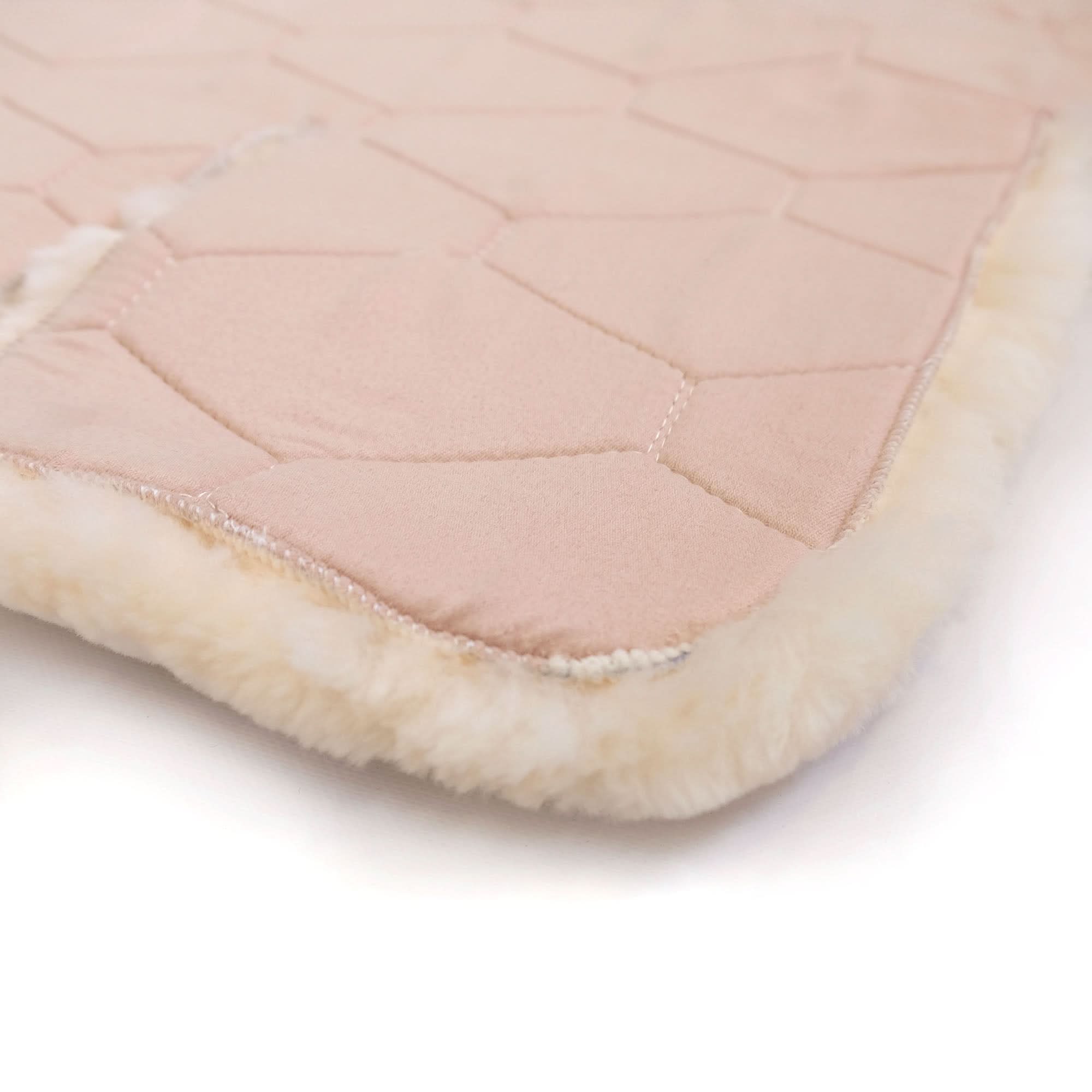 Blush pink quilted sheepskin throw with cream wool lining, folded edge detail. - Yellow Earth Australia