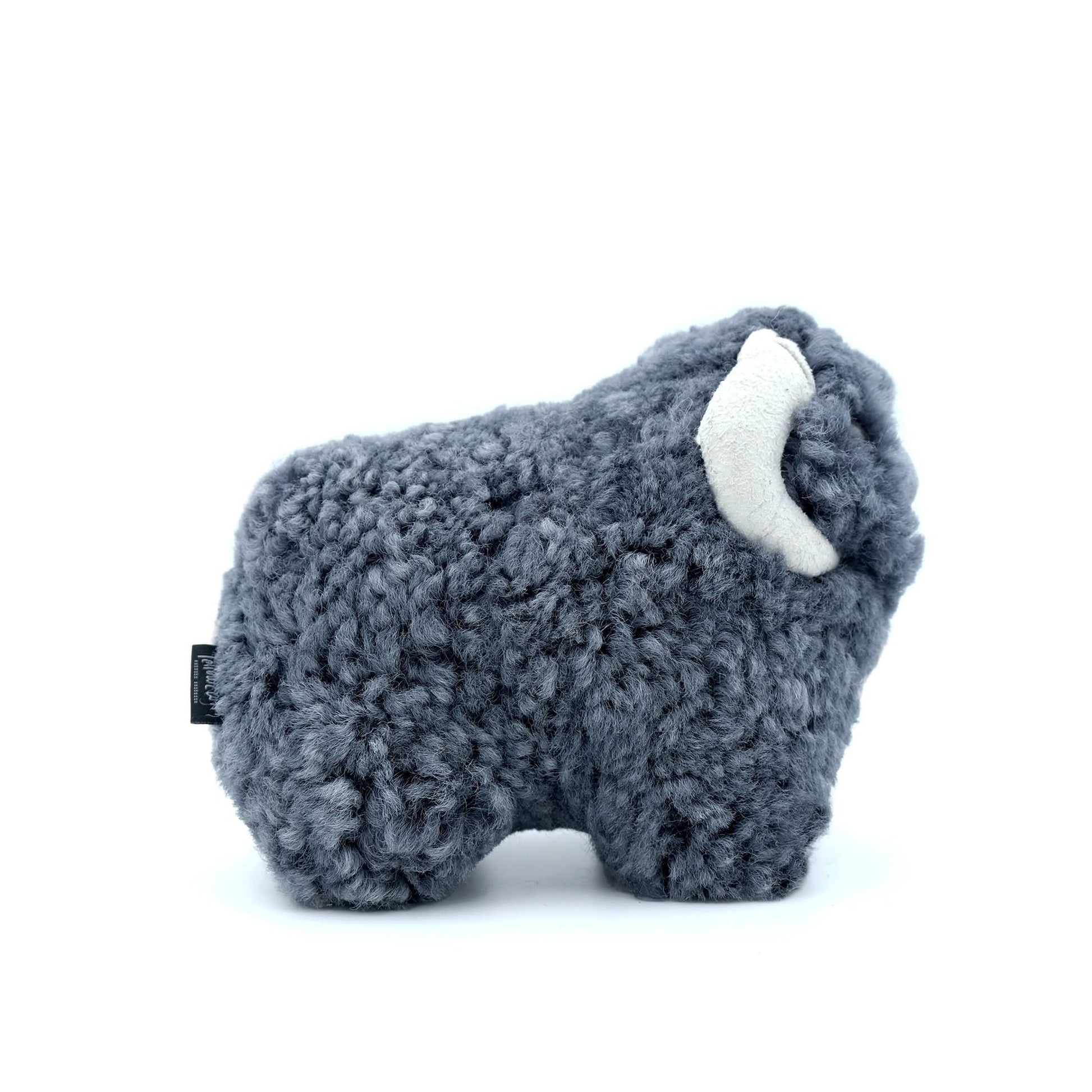 Fluffy grey sheepskin toy elephant with white tusks, side view. - Yellow Earth Australia