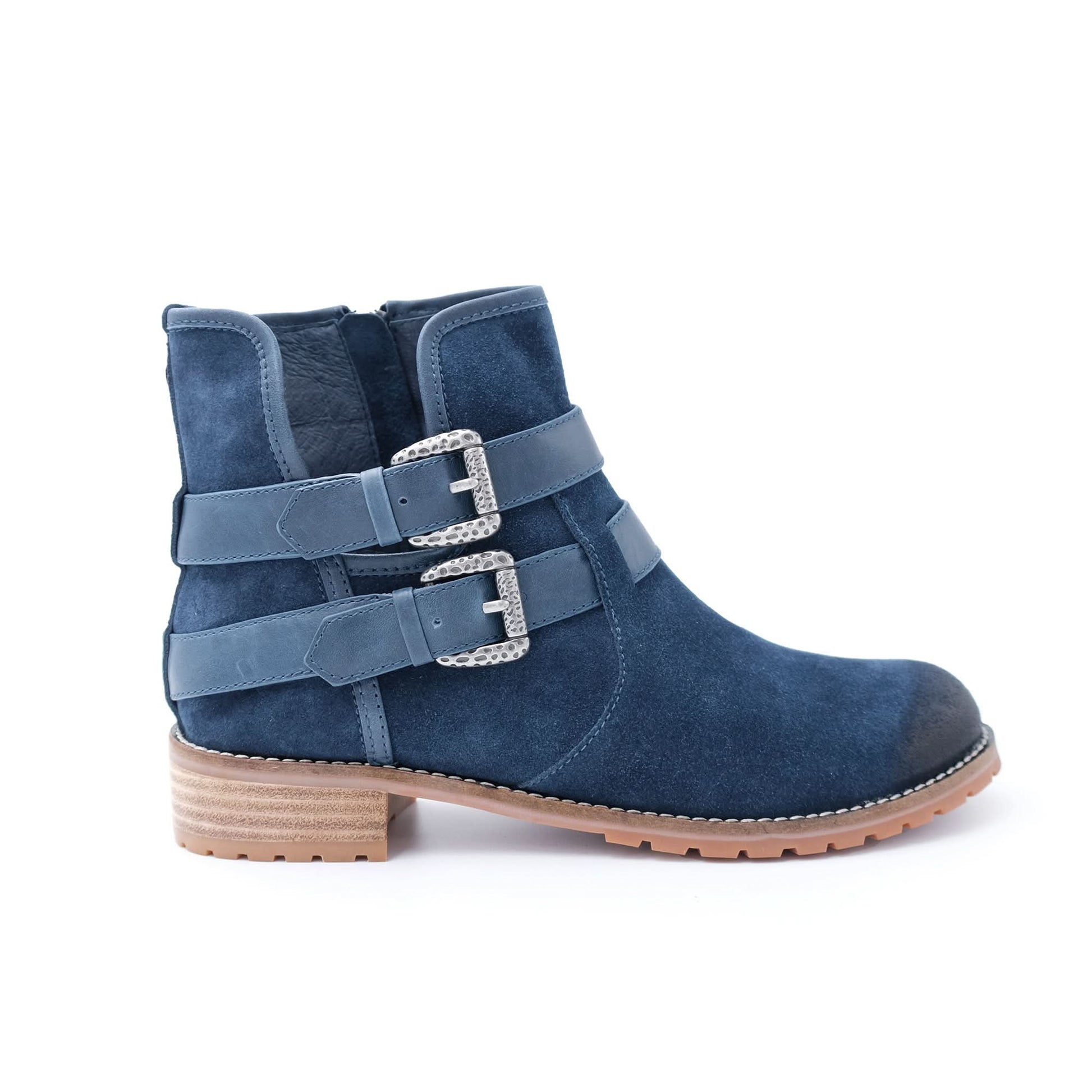 Navy blue suede ankle boot with double buckle straps and low wooden heel on white background
