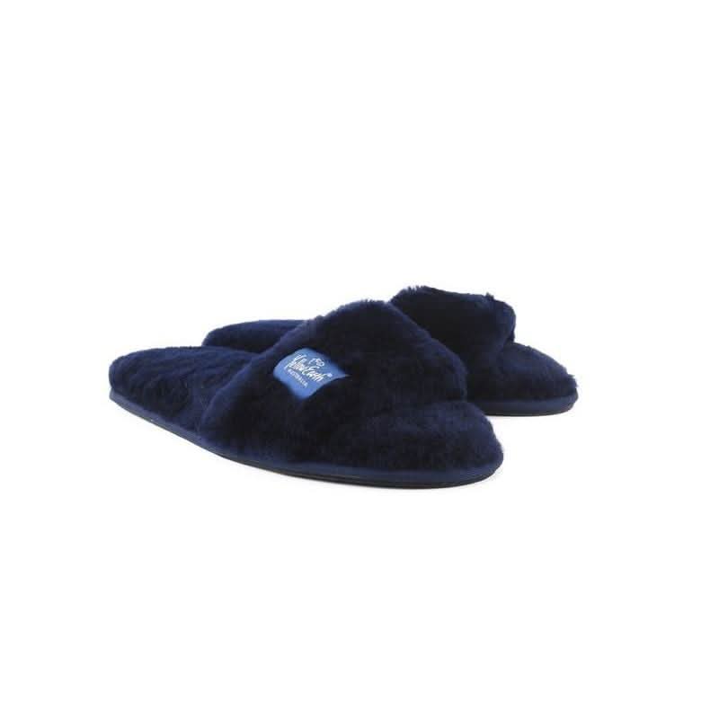 Navy blue sheepskin slippers with fuzzy wool upper, angled side view. - Yellow Earth Australia