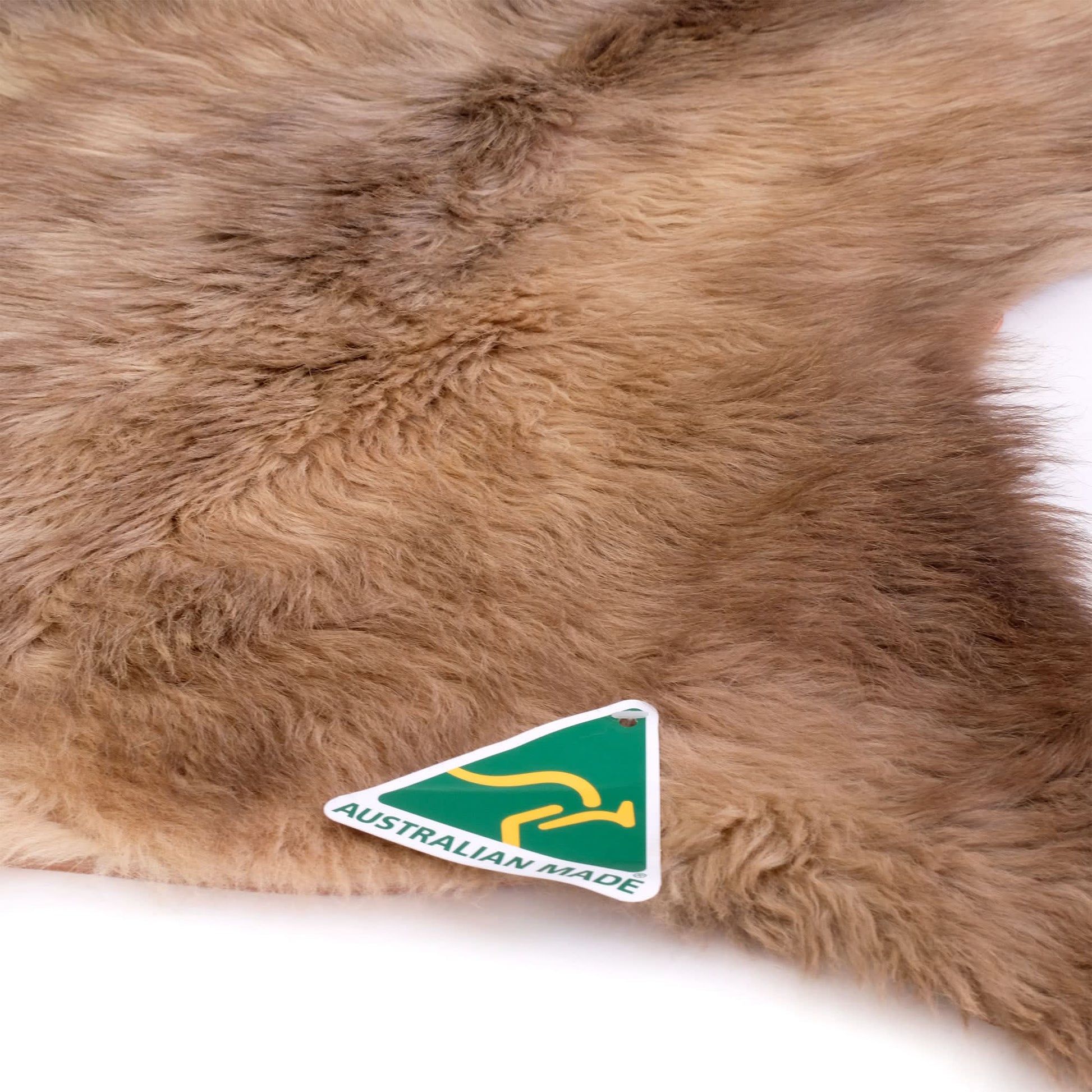 Caramel sheepskin rug with soft wool texture viewed from above. - Yellow Earth Australia