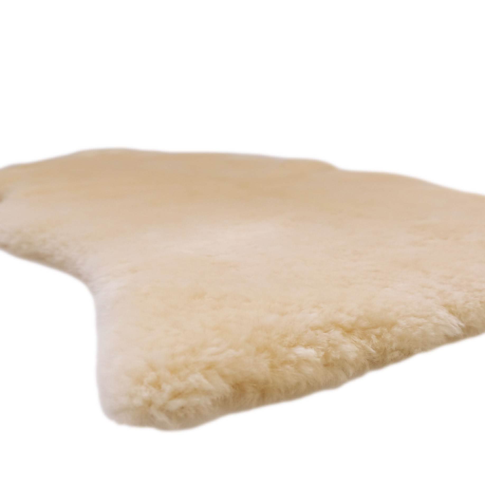 Cream sheepskin rug with soft wool texture, angled side view. - Yellow Earth Australia