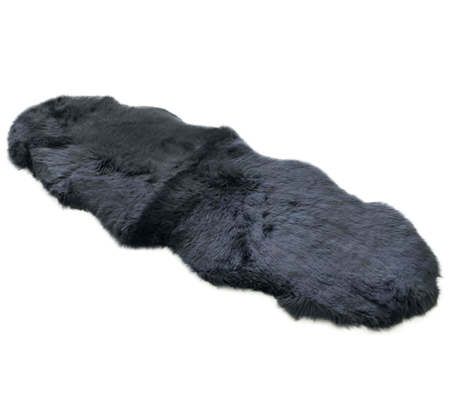 Black sheepskin rug with soft wool pile viewed from above on white background. - Yellow Earth Australia