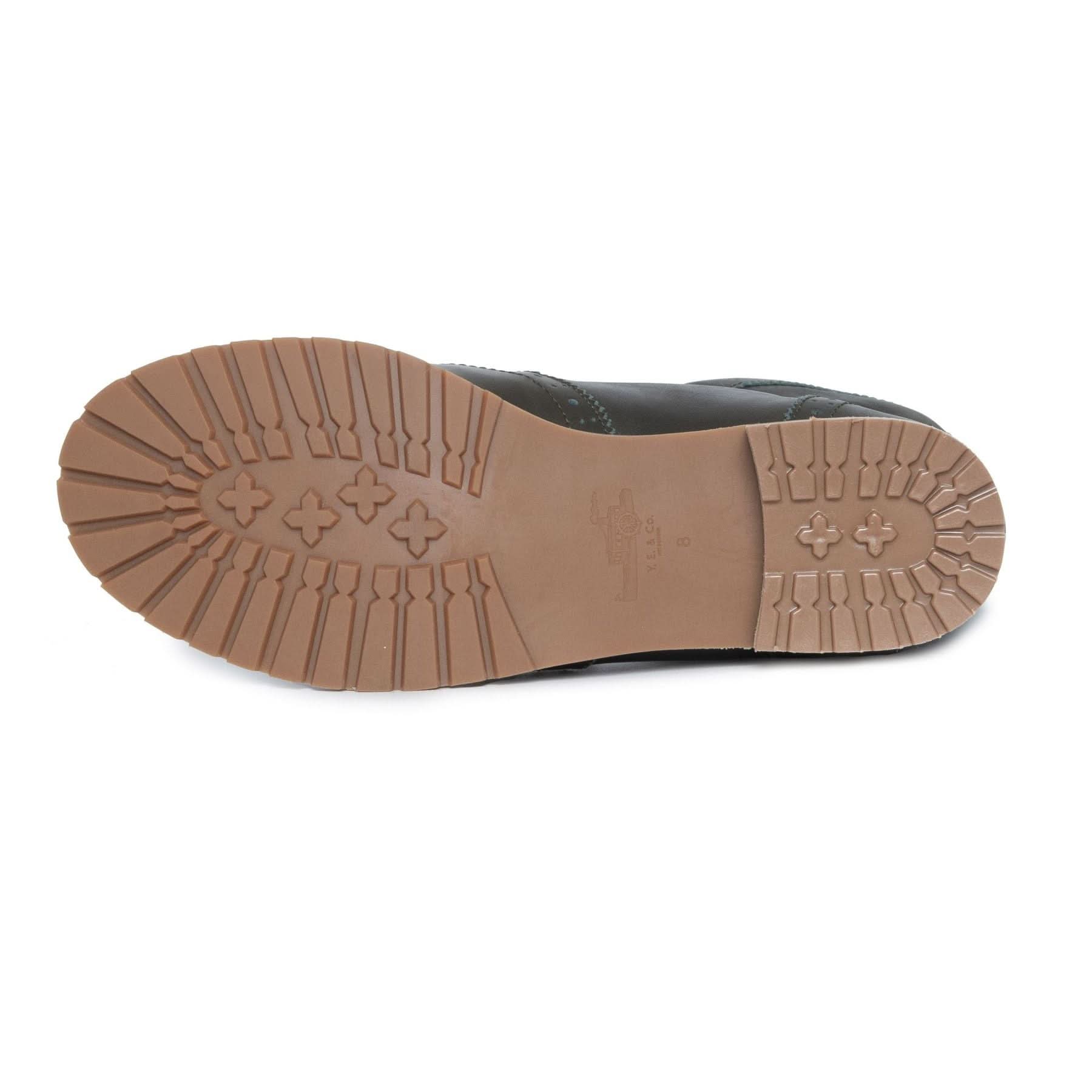 Black sheepskin boot sole showing tan rubber tread pattern from underneath view. - Yellow Earth Australia