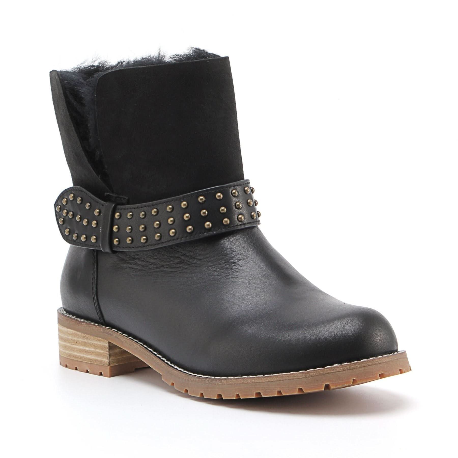 Black leather sheepskin boots with studded strap and lug sole, angled side view. - Yellow Earth Australia