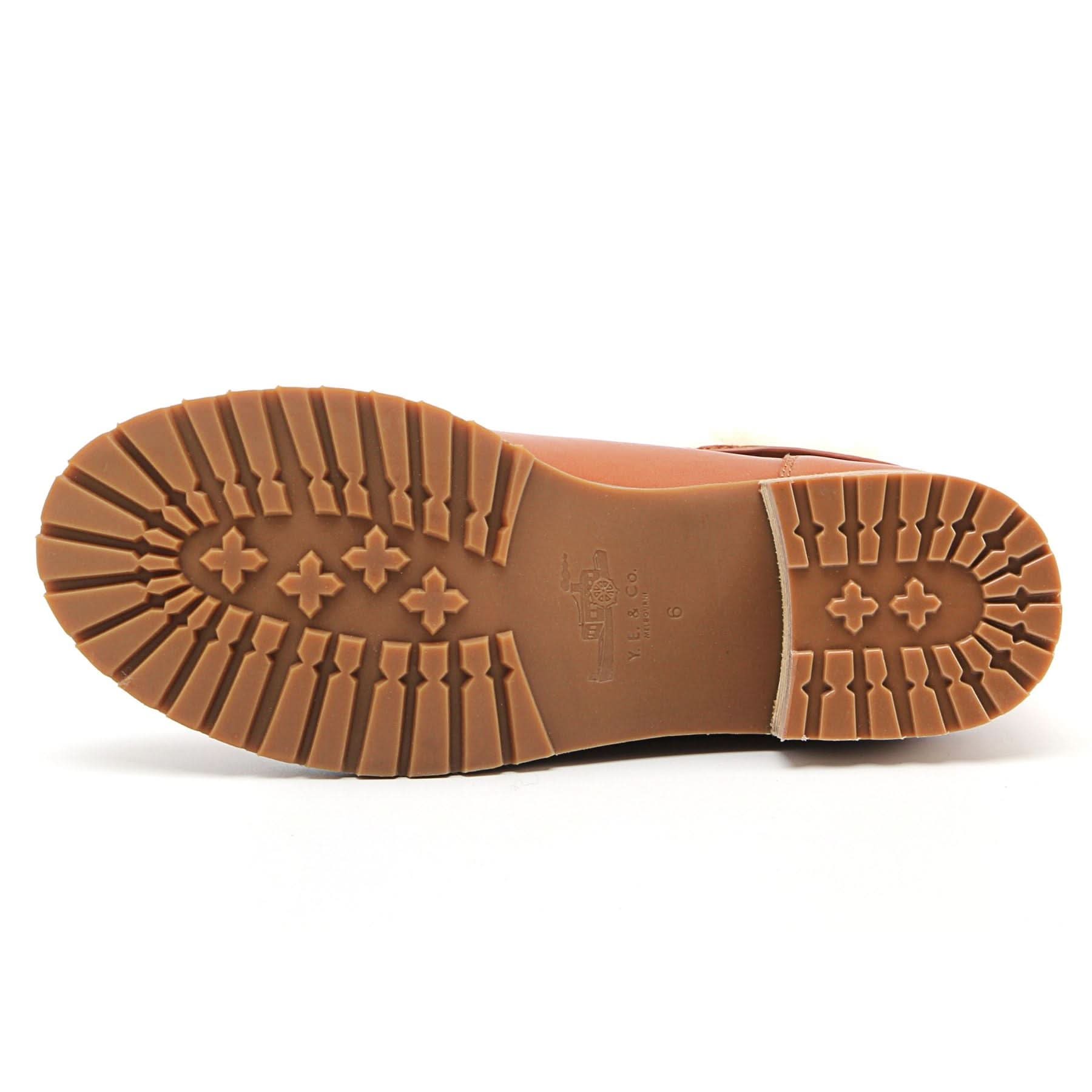 Tan leather boot sole showing textured tread pattern and four-leaf clover design detail. - Yellow Earth Australia