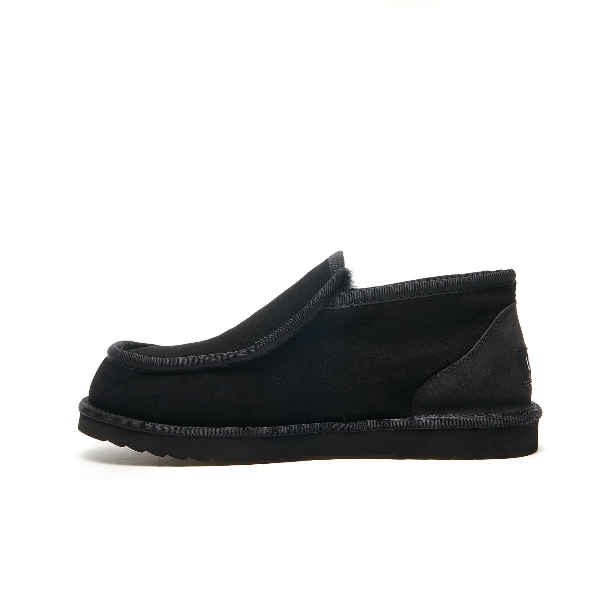 Black sheepskin slip-on loafer slipper with wool lining, side view. - Yellow Earth Australia