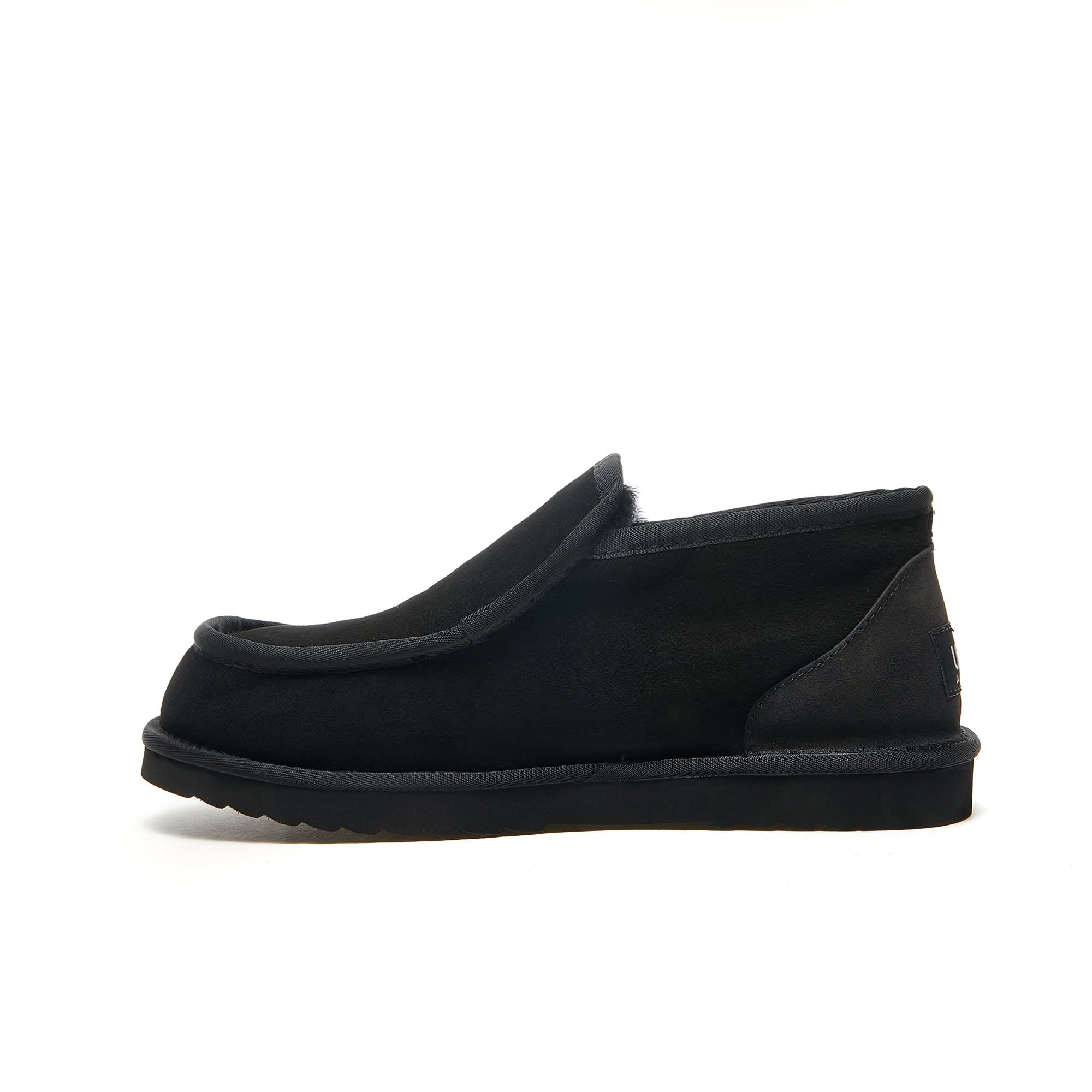 Black sheepskin slip-on loafer slipper with wool lining, side view. - Yellow Earth Australia