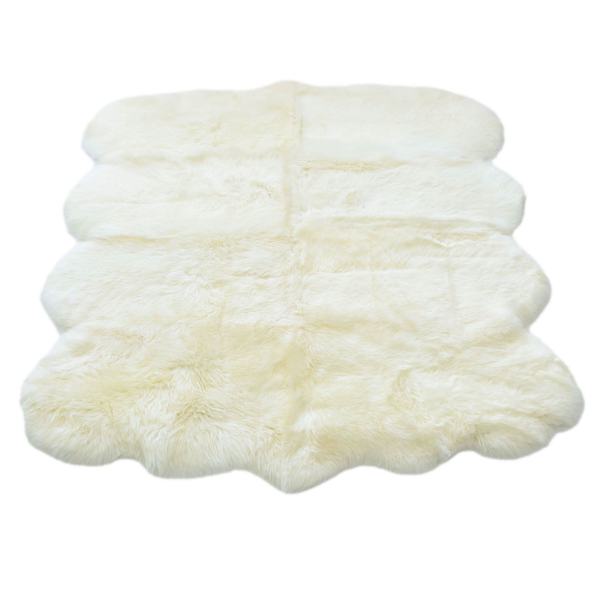 Stacked ivory sheepskin rugs with fluffy wool texture viewed from above. - Yellow Earth Australia