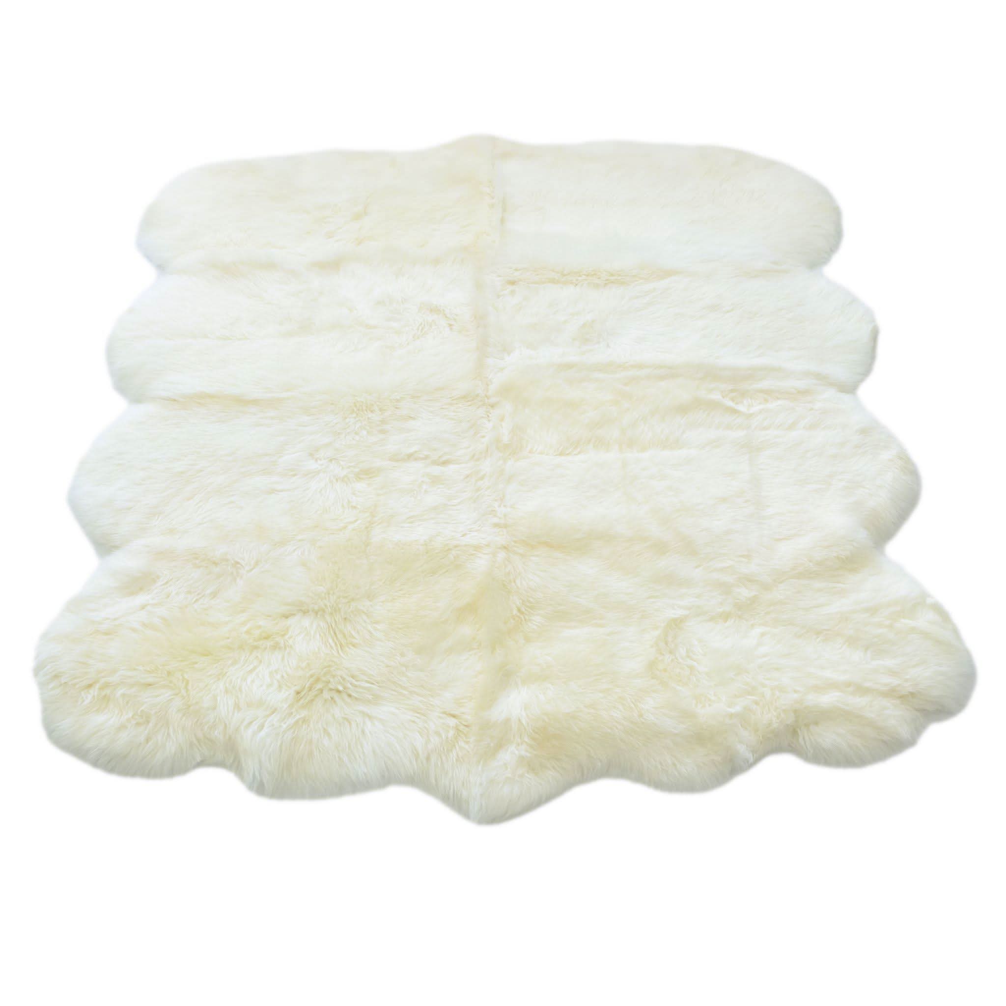 Stacked ivory sheepskin rugs with fluffy wool texture viewed from above. - Yellow Earth Australia